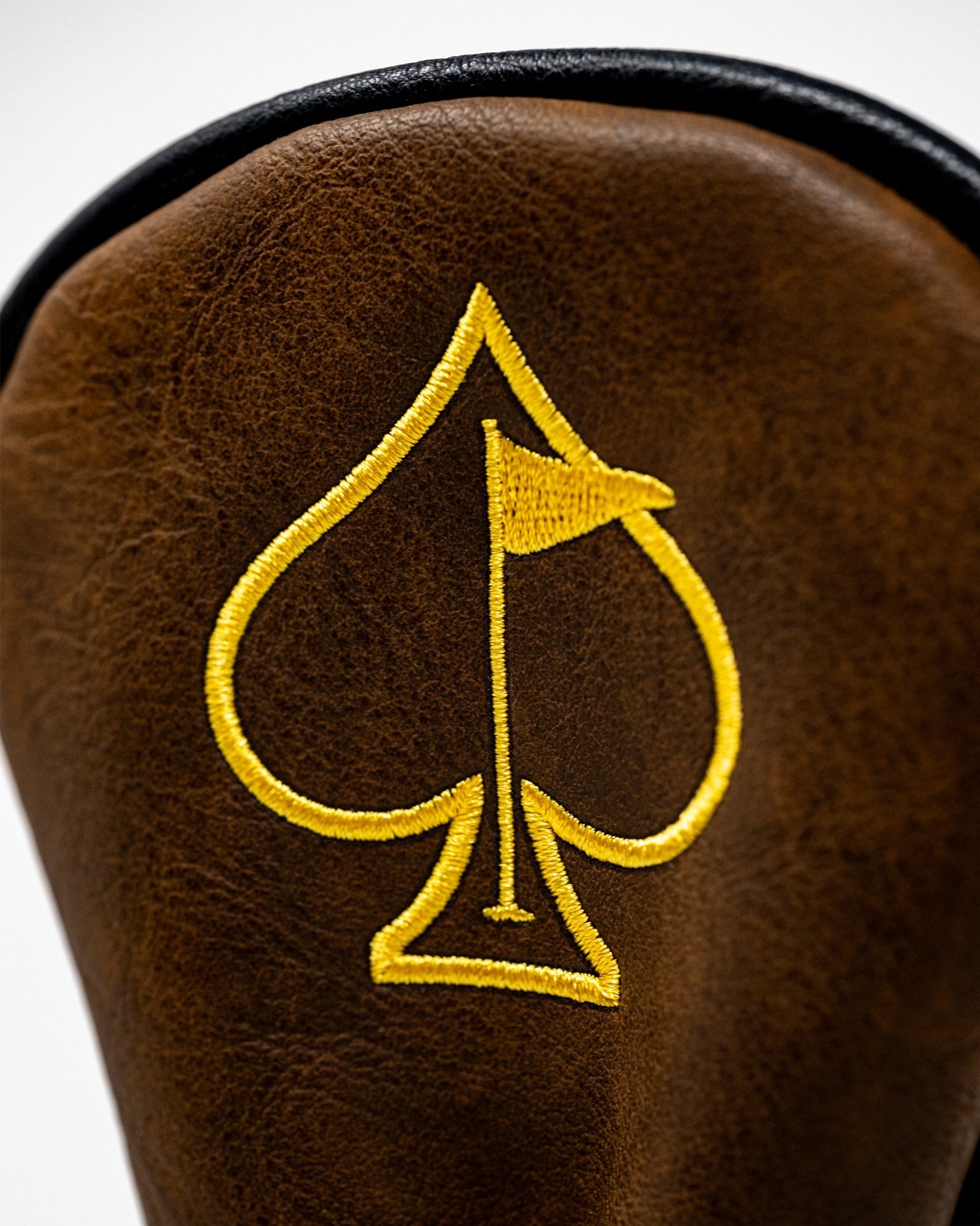 Yellowstone Hybrid Cover featuring a brown leather design with a yellow spade and flag emblem, perfect for stylish golfers.
