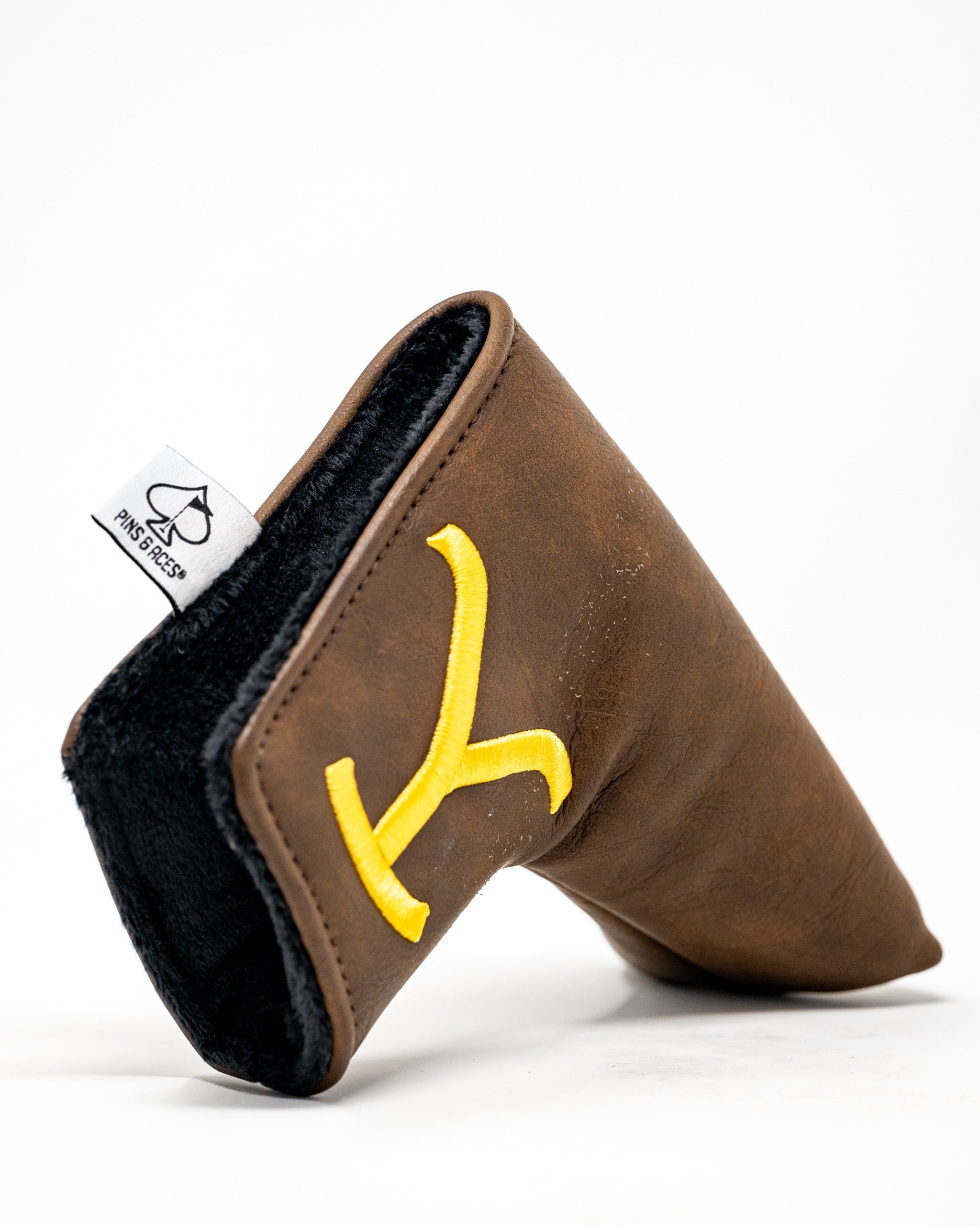 Yellowstone blade putter cover in brown leather with a yellow logo, featuring a soft interior lining for protection.
