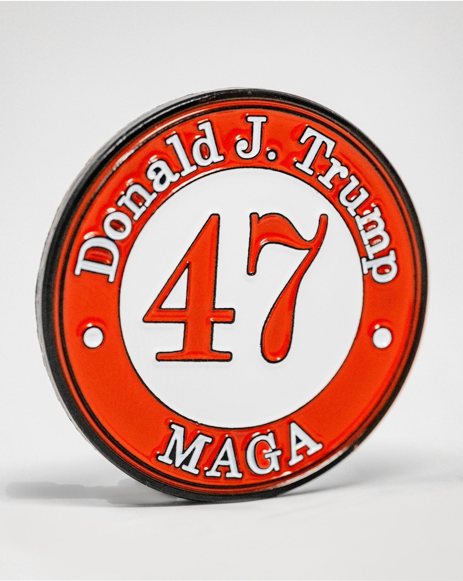 Bold golf ball marker featuring the number 47 and "Donald J. Trump" with "MAGA" in a striking red and white design.