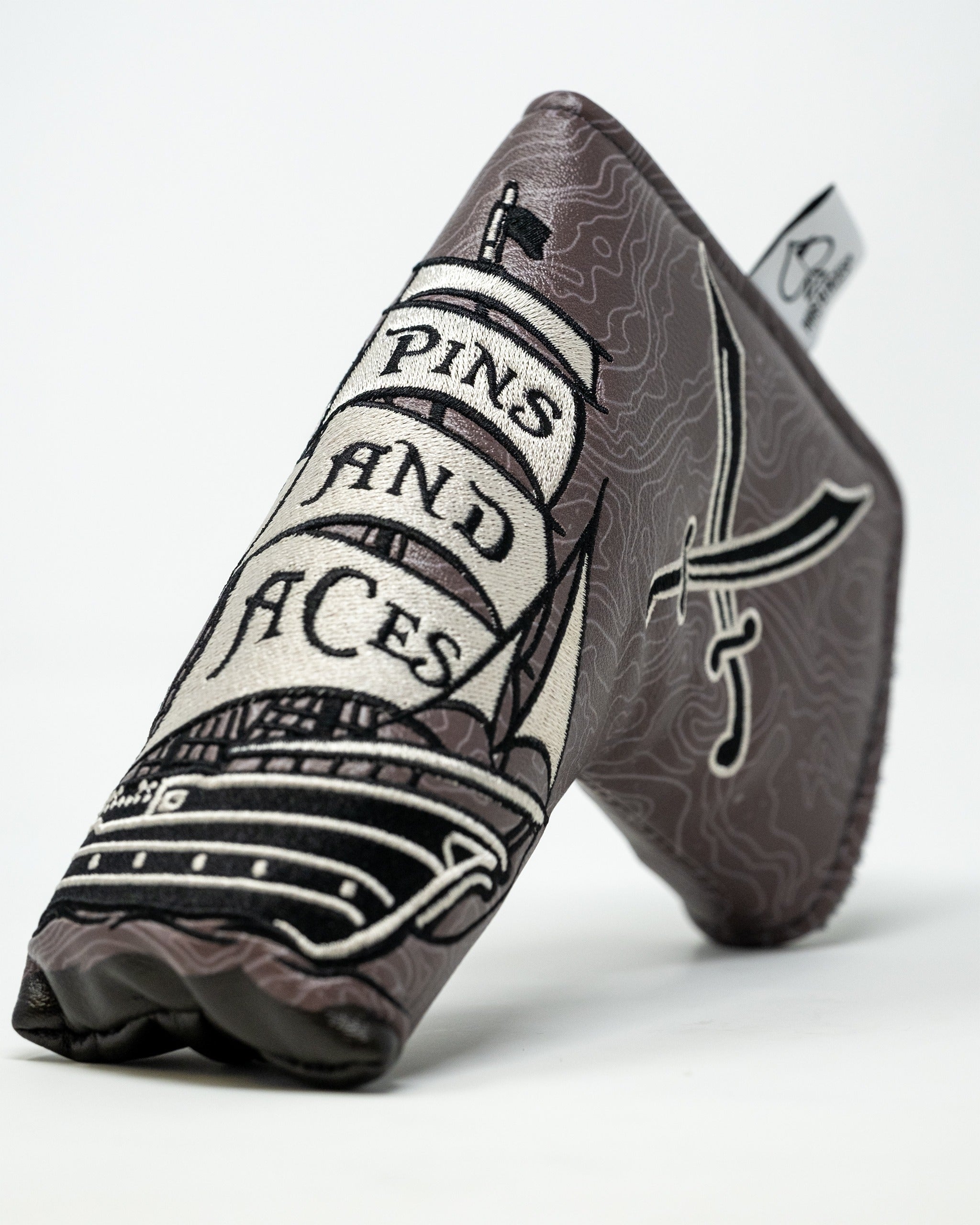 Bold pirate-themed blade putter cover featuring a ship and sword design, perfect for golfers who want to stand out.