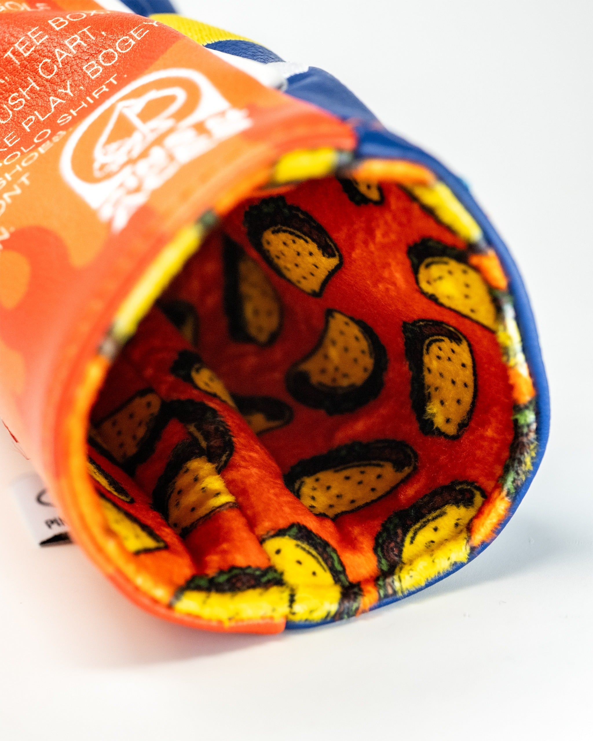 Bold golf headcover featuring a vibrant hot sauce design with taco patterns inside, perfect for unique style on the course.
