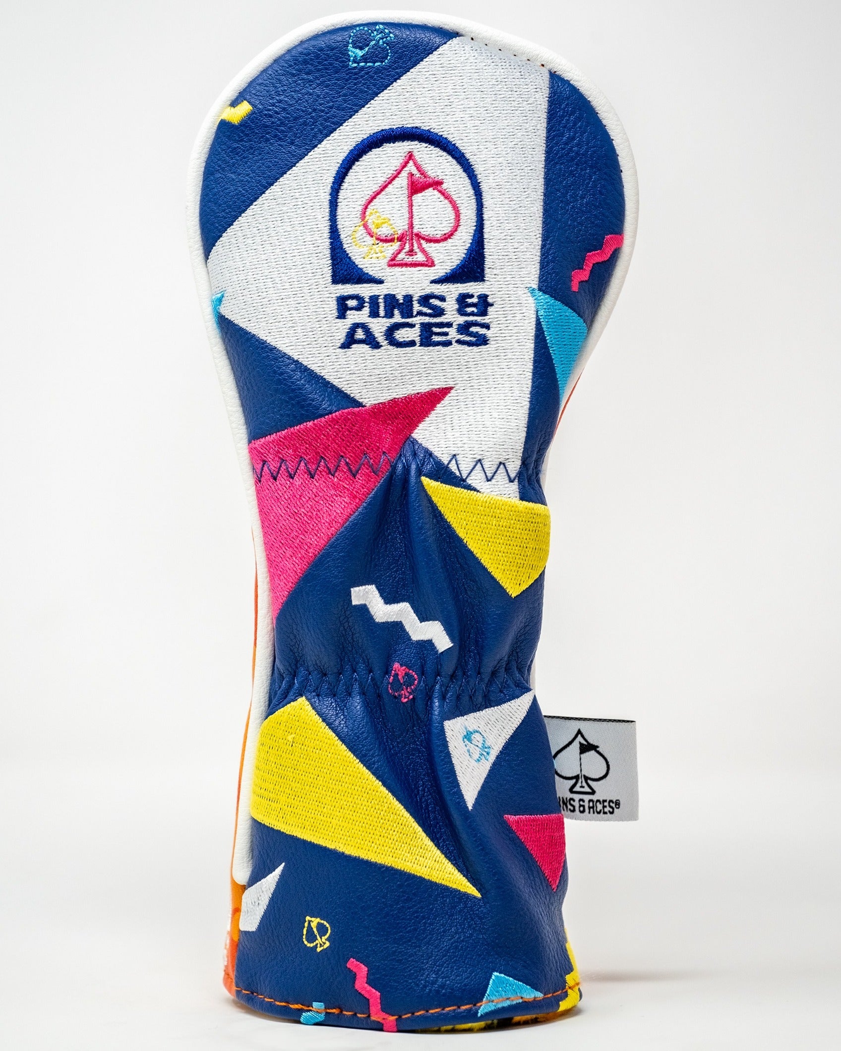 Bold golf hybrid cover featuring a vibrant geometric design in blue, yellow, pink, and white with the Pins & Aces logo.
