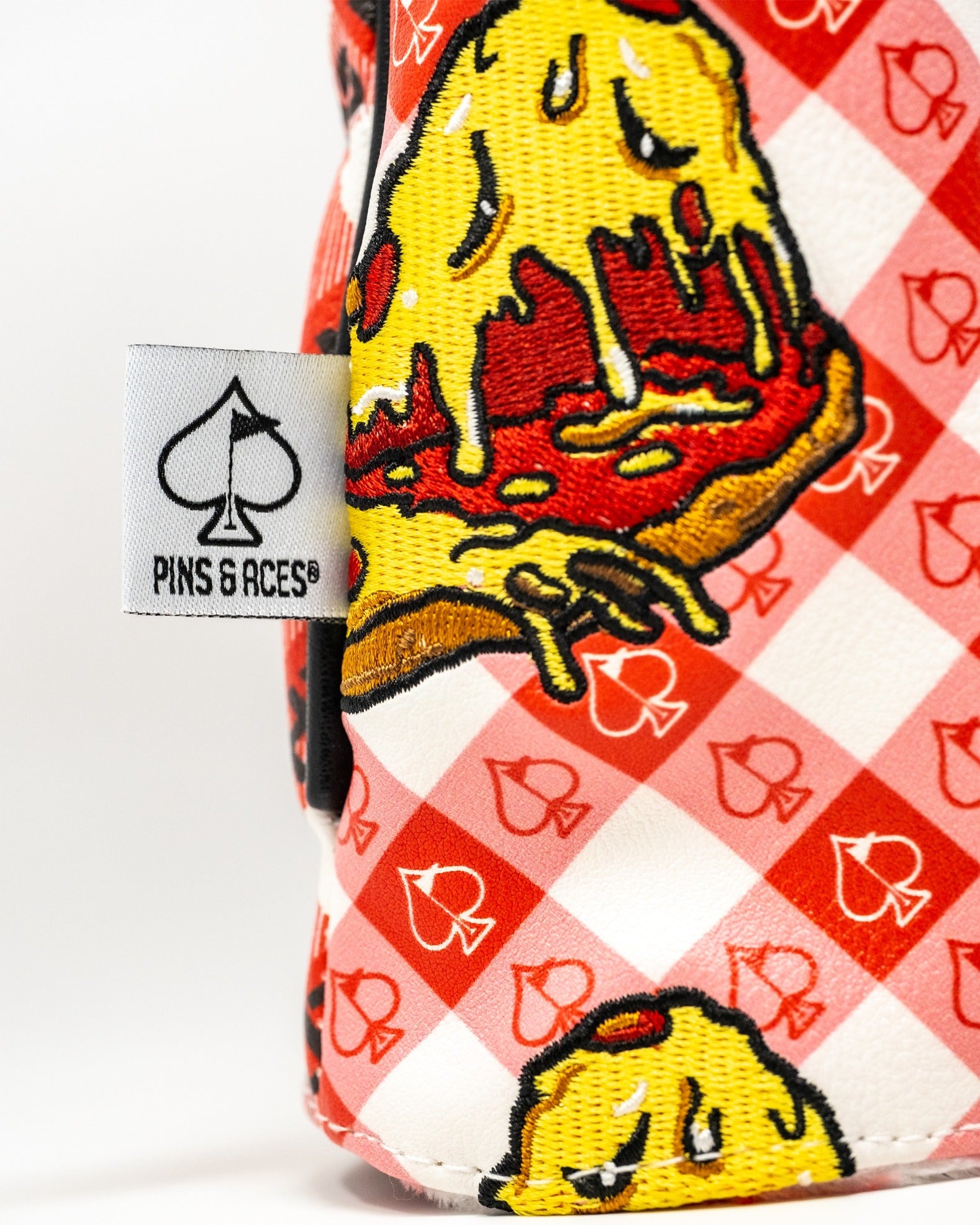 Colorful fairway cover featuring a playful pizza design on a checkered background, perfect for stylish golfers.