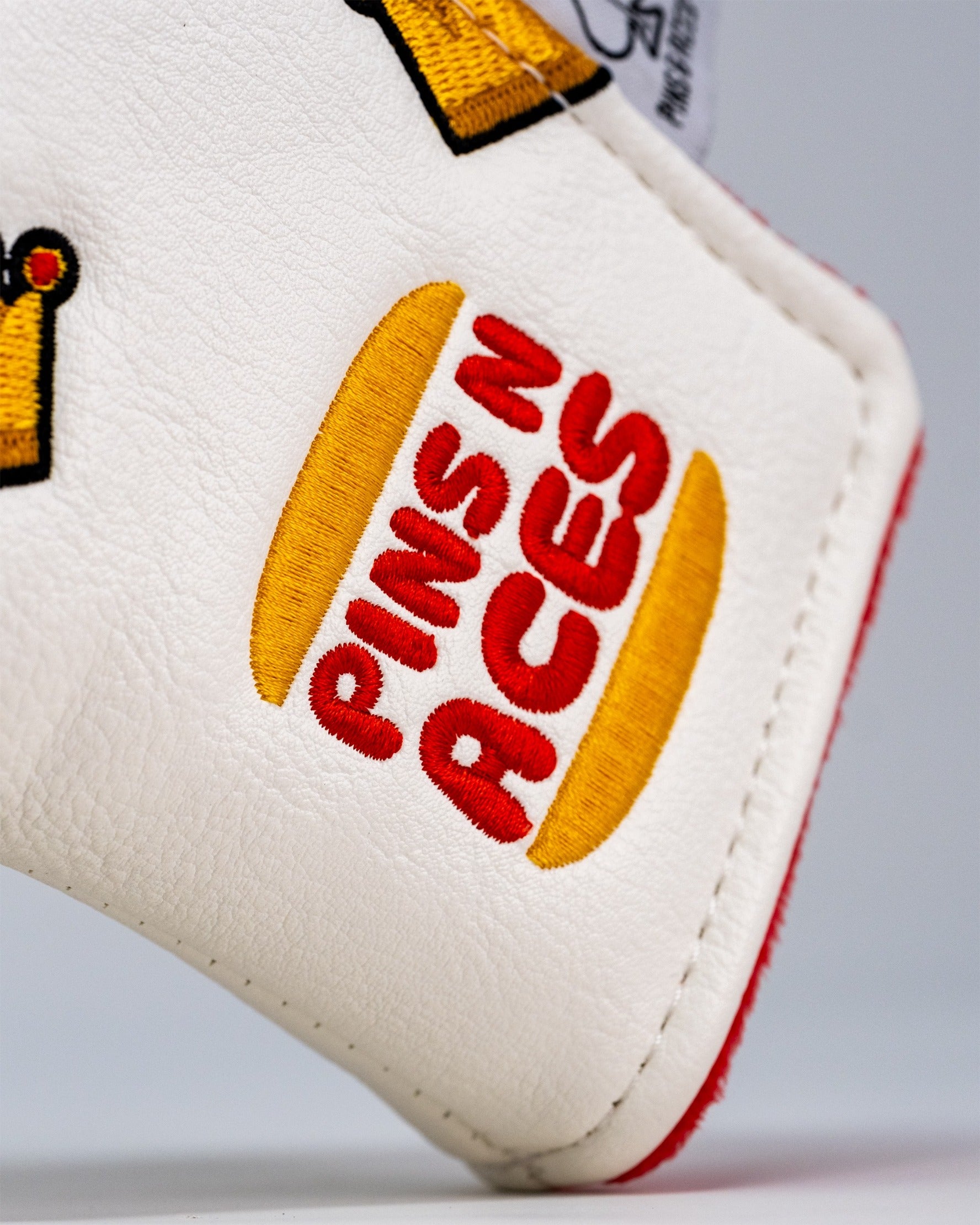 Close-up of the Bogey King blade putter headcover featuring vibrant embroidery and the Pins N Aces logo.