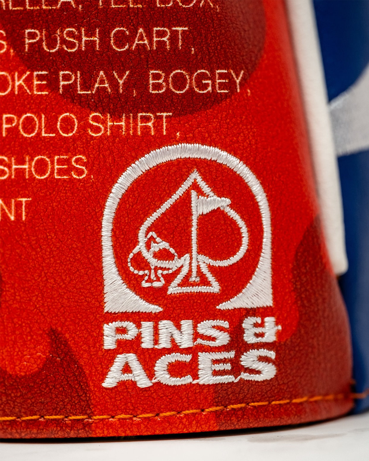 Bold red driver cover featuring a fiery design, showcasing the Pins & Aces logo for standout golf style.