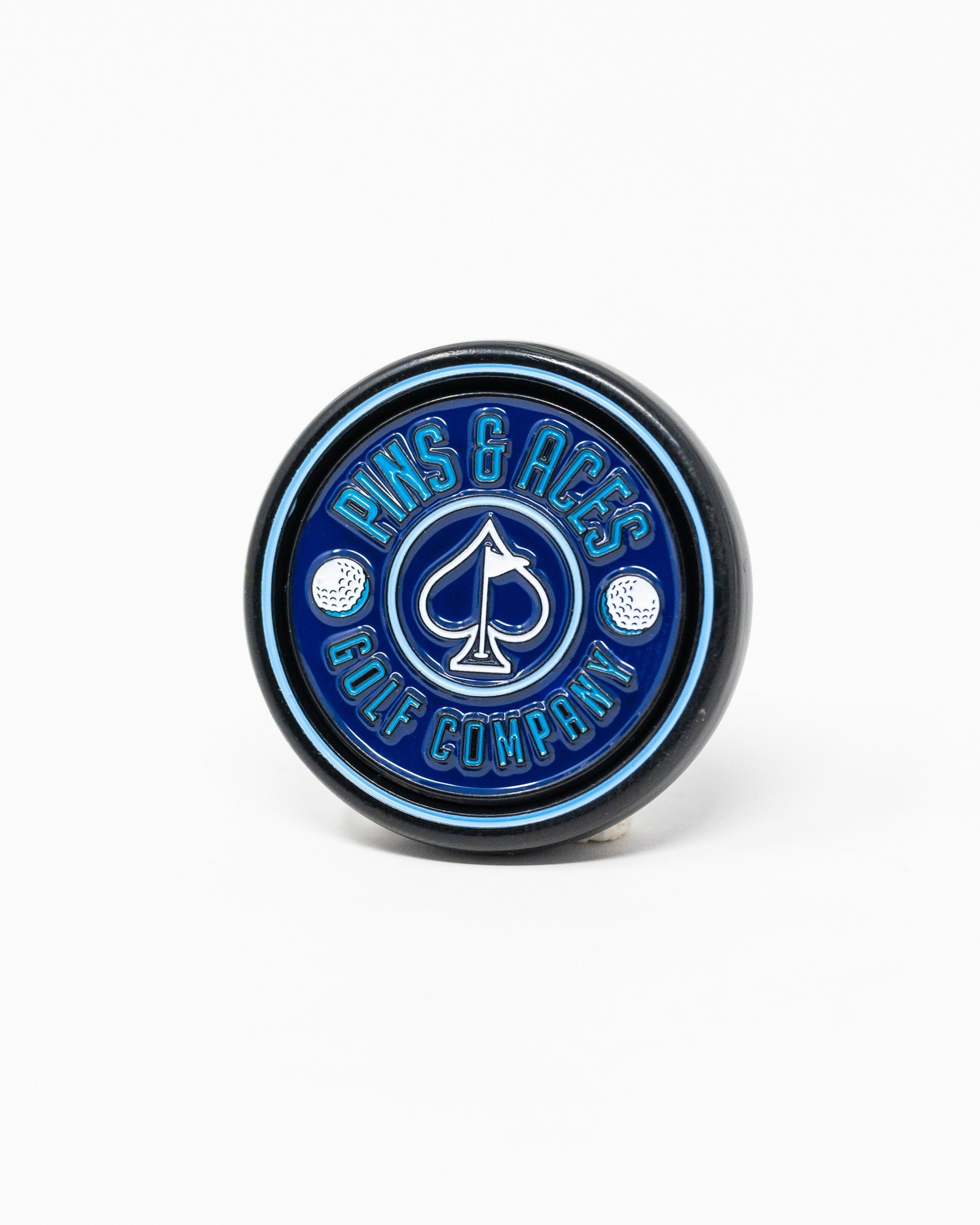 Navy pop-out medallion ball marker featuring the Pins and Aces logo, designed for stylish golf enthusiasts.
