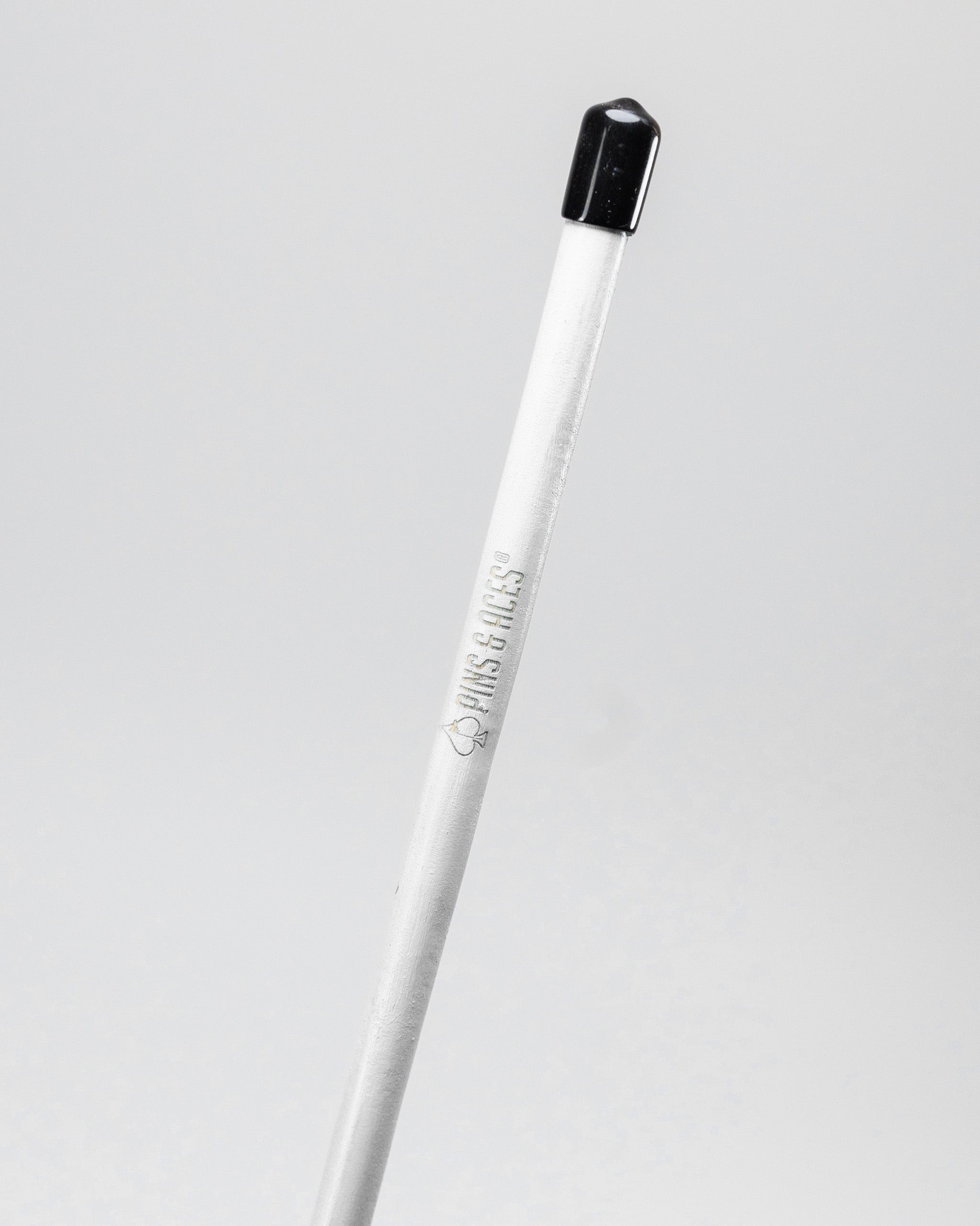 White alignment stick with a black tip, designed for golfers to improve their stance and alignment on the course.
