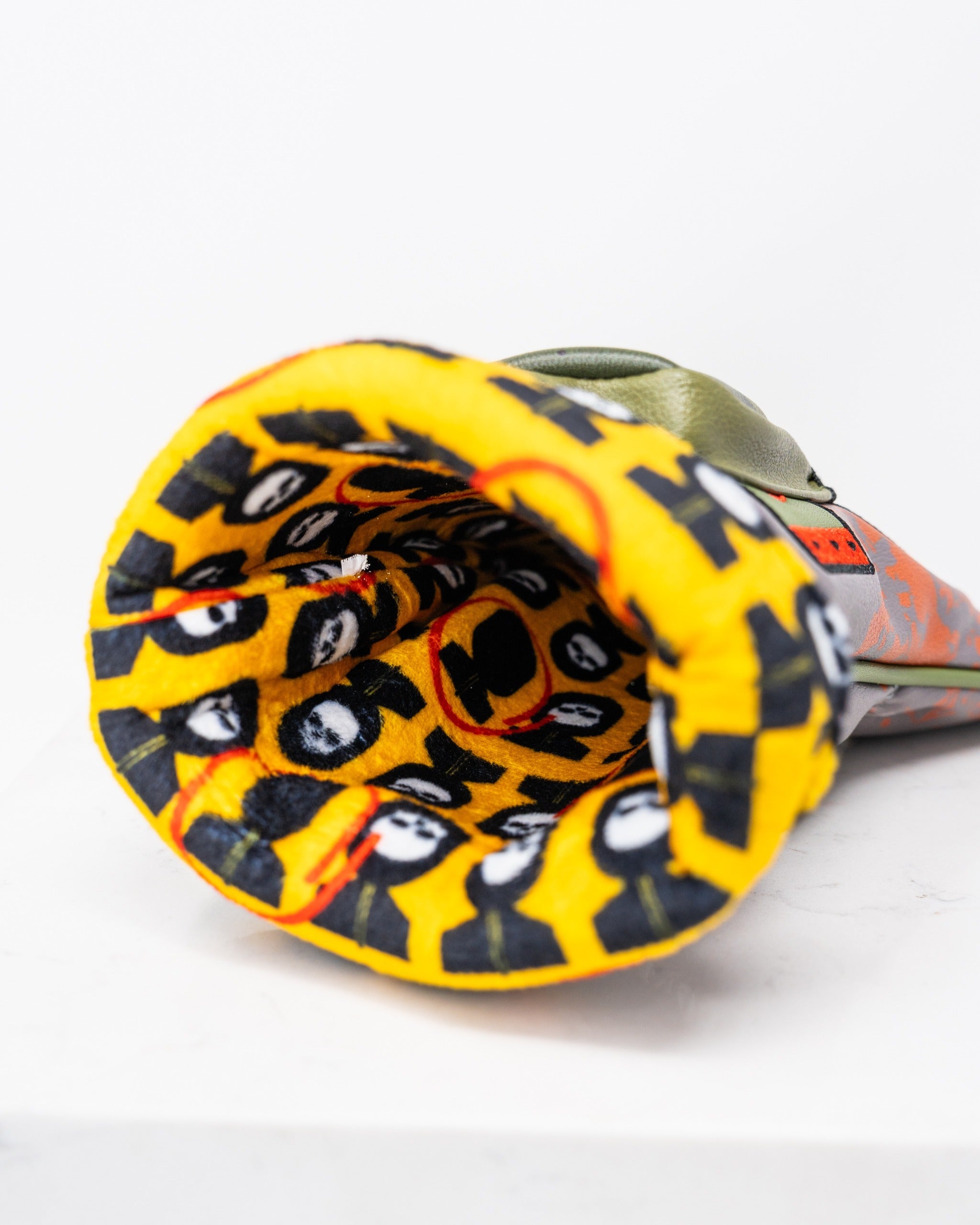 Bold golf driver cover featuring a vibrant yellow interior with playful graphics, designed to make a statement on the course.