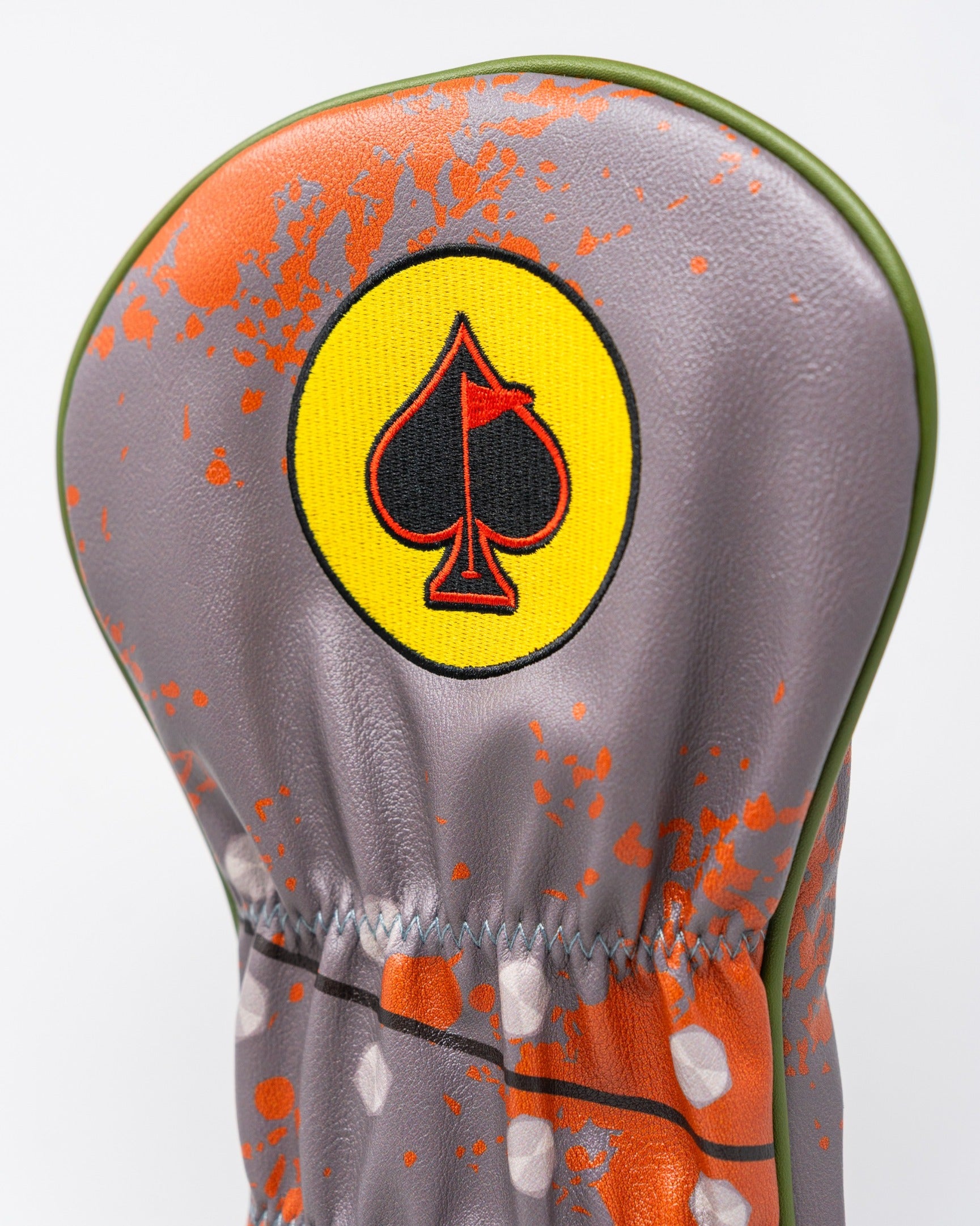 Bold golf driver cover featuring a vibrant design with a spade logo, perfect for golfers who want to stand out.