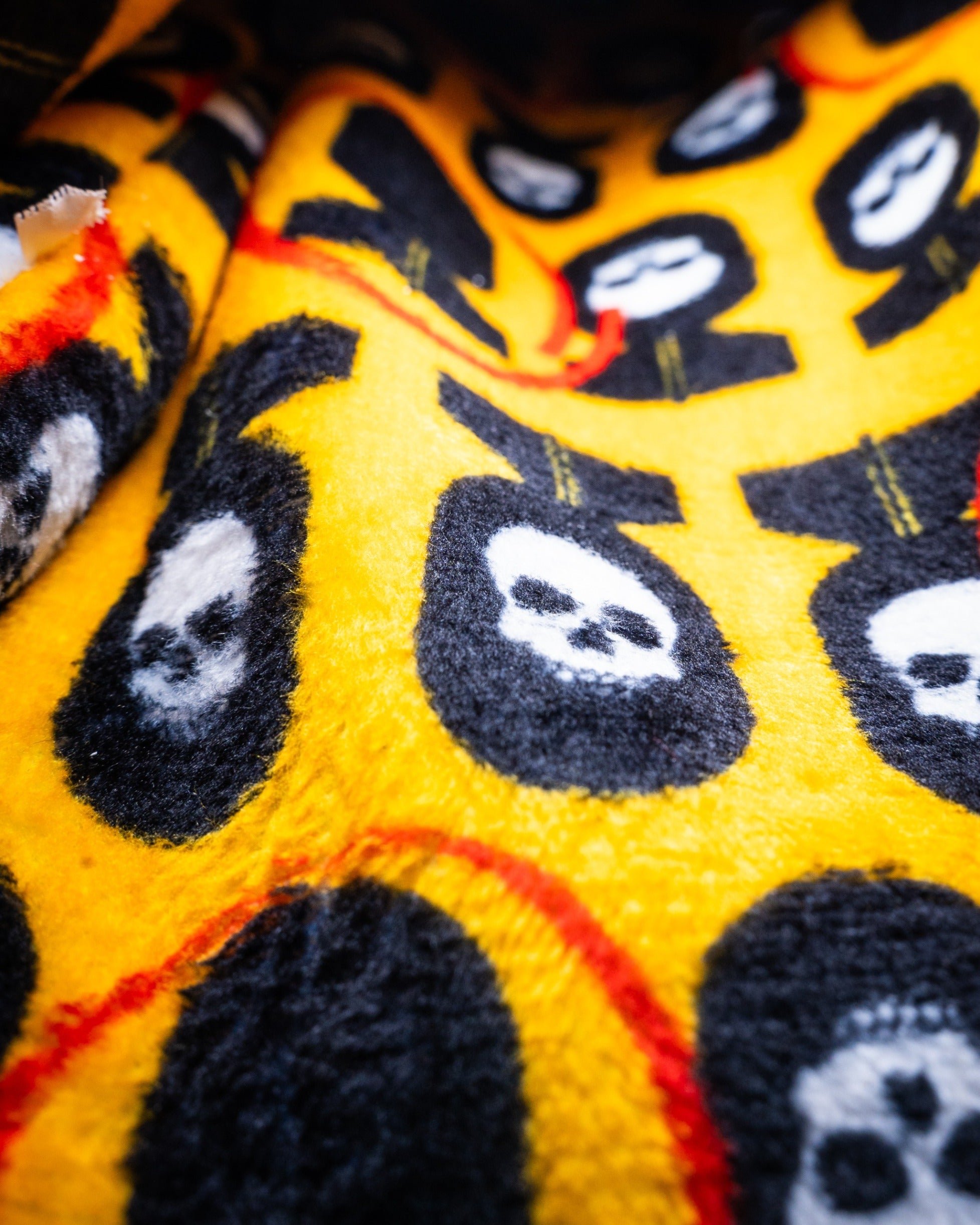 Bold driver cover featuring a vibrant yellow background with playful skull designs, perfect for golfers wanting to stand out.