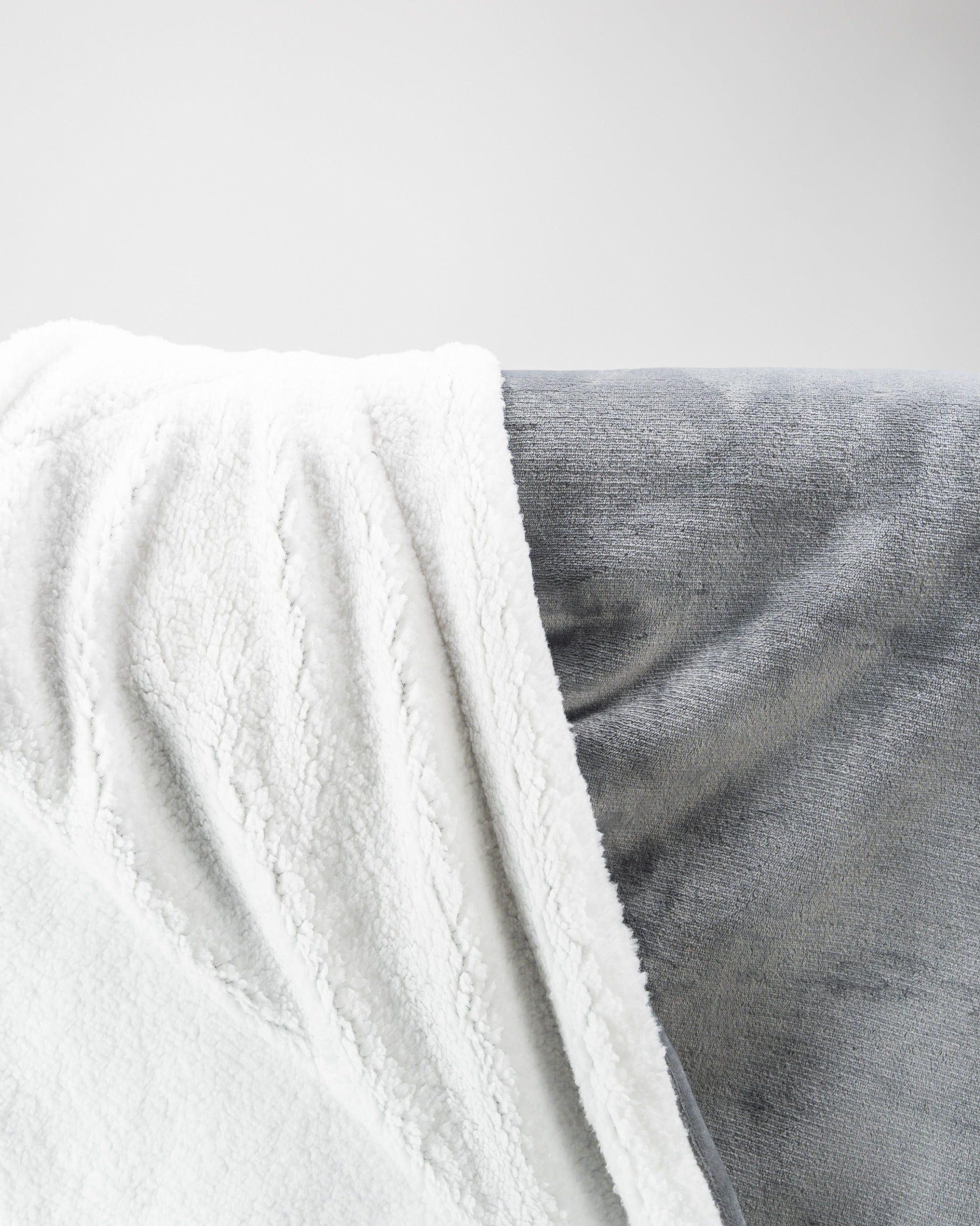 Light gray Bogey Blanket featuring a soft, plush texture, perfect for cozying up after a round of golf.