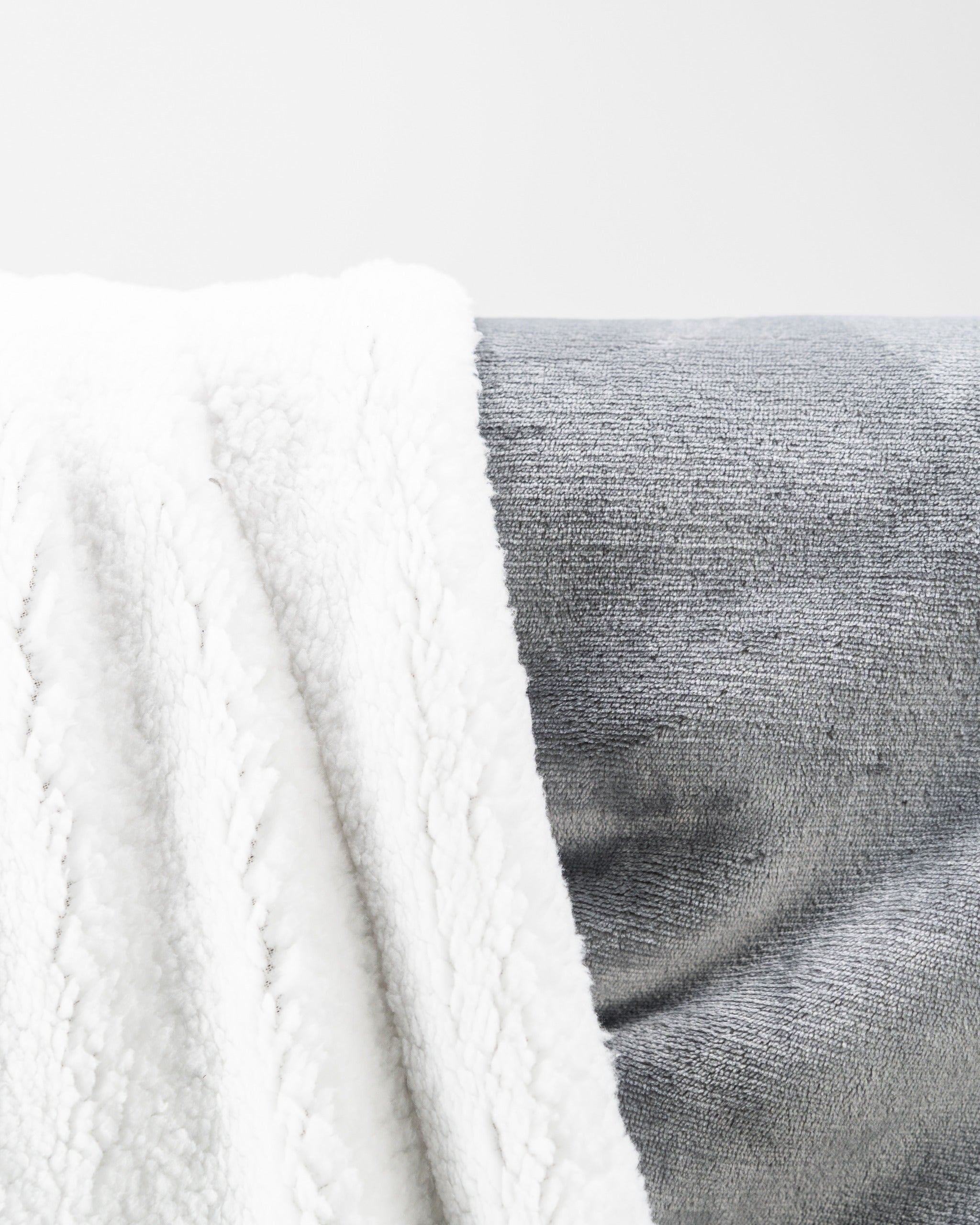 Light gray Bogey Blanket featuring a soft, textured surface and cozy white fleece for warmth on the golf course.