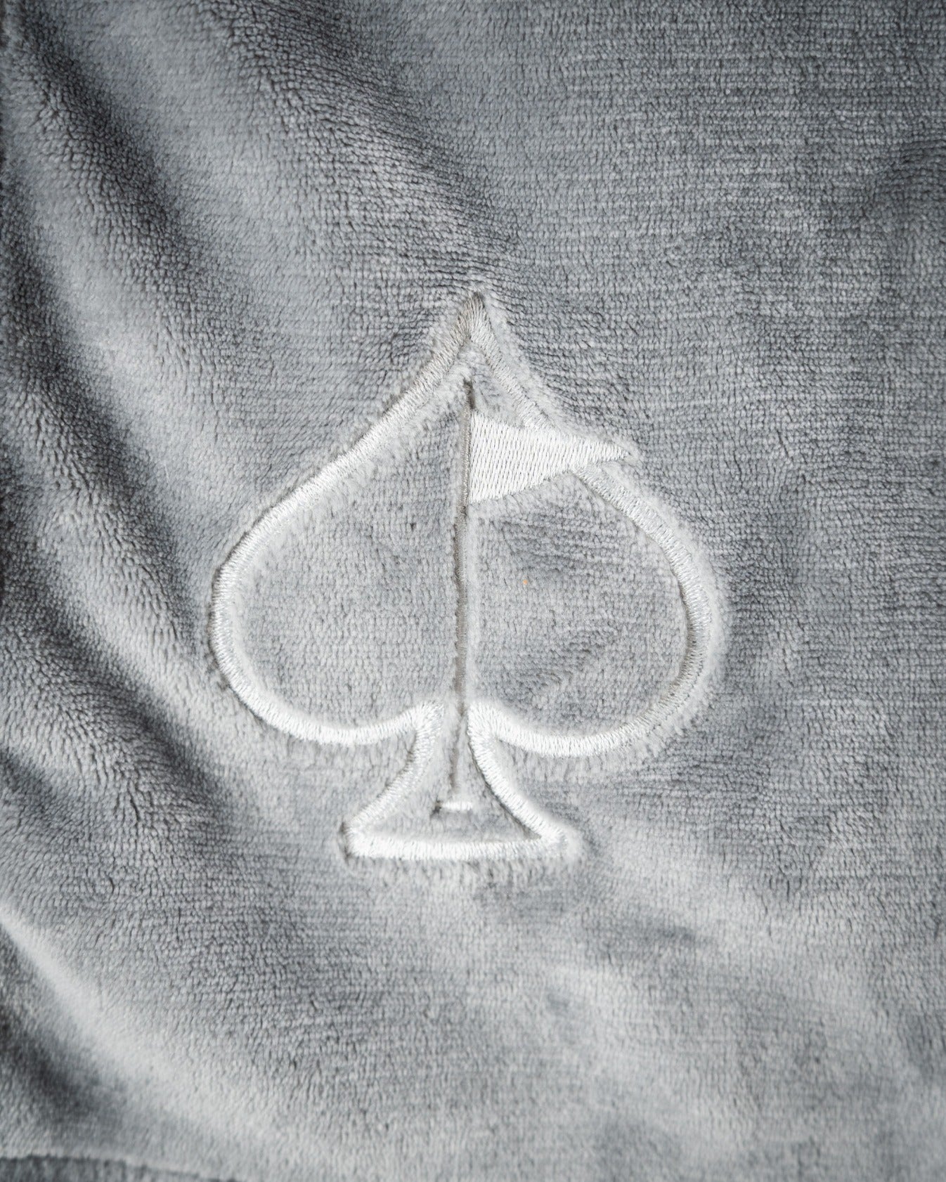 Light gray Bogey Blanket featuring a subtle embroidered spade logo, perfect for cozying up on the golf course.