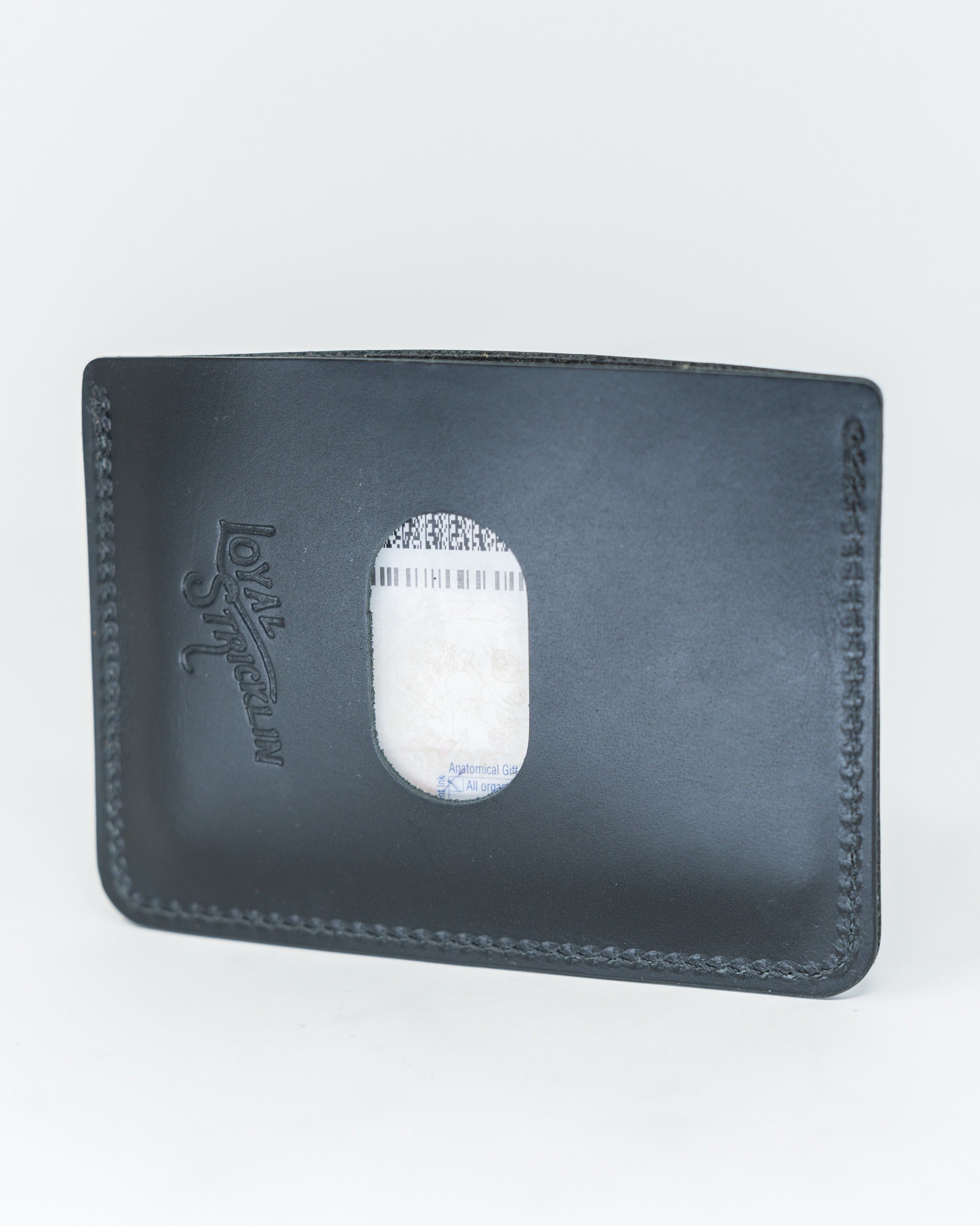 Sleek smooth Italian black wallet featuring a transparent ID window and stitched detailing for a modern look.