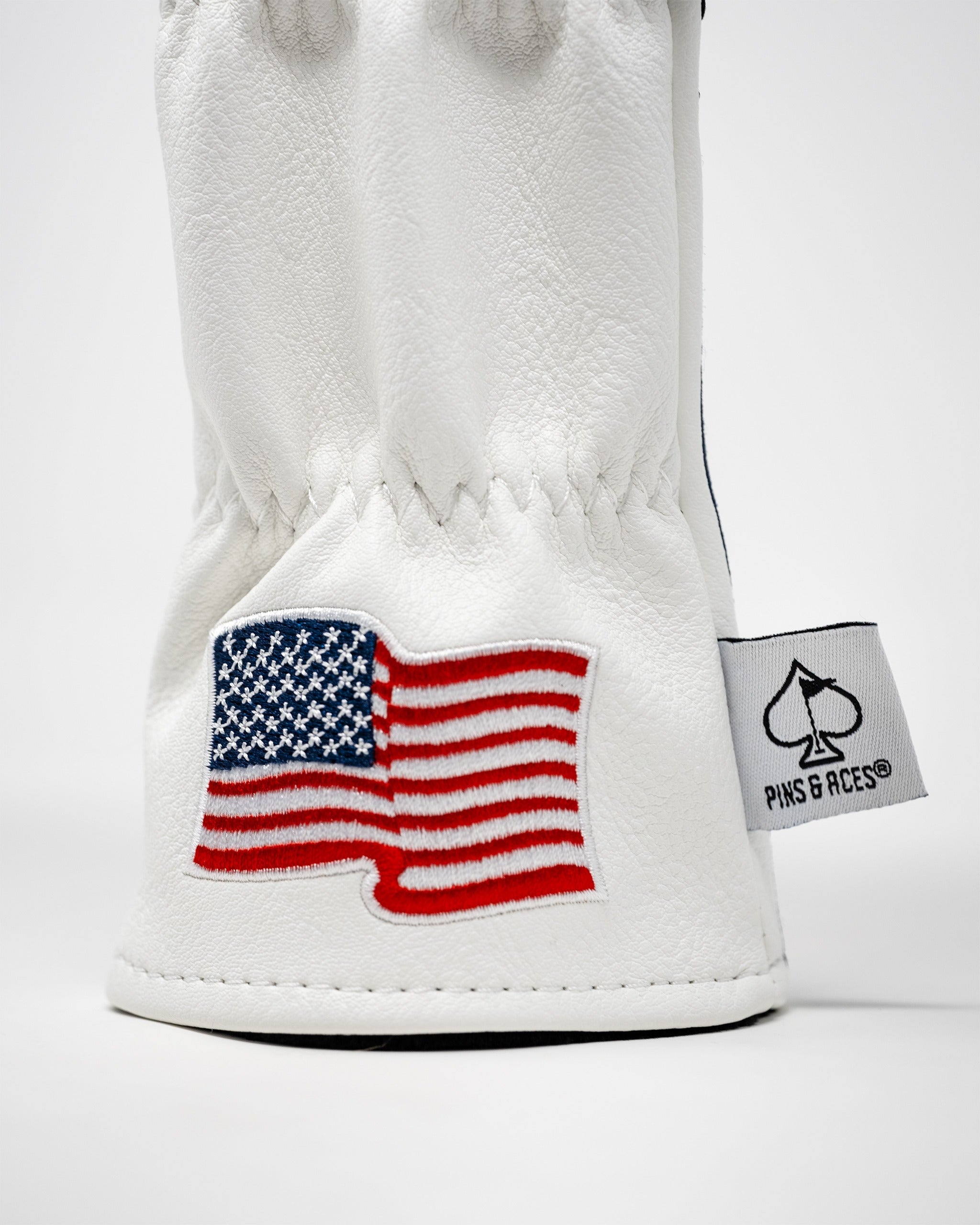White hybrid golf cover featuring an embroidered American flag design, perfect for golfers seeking a patriotic style.