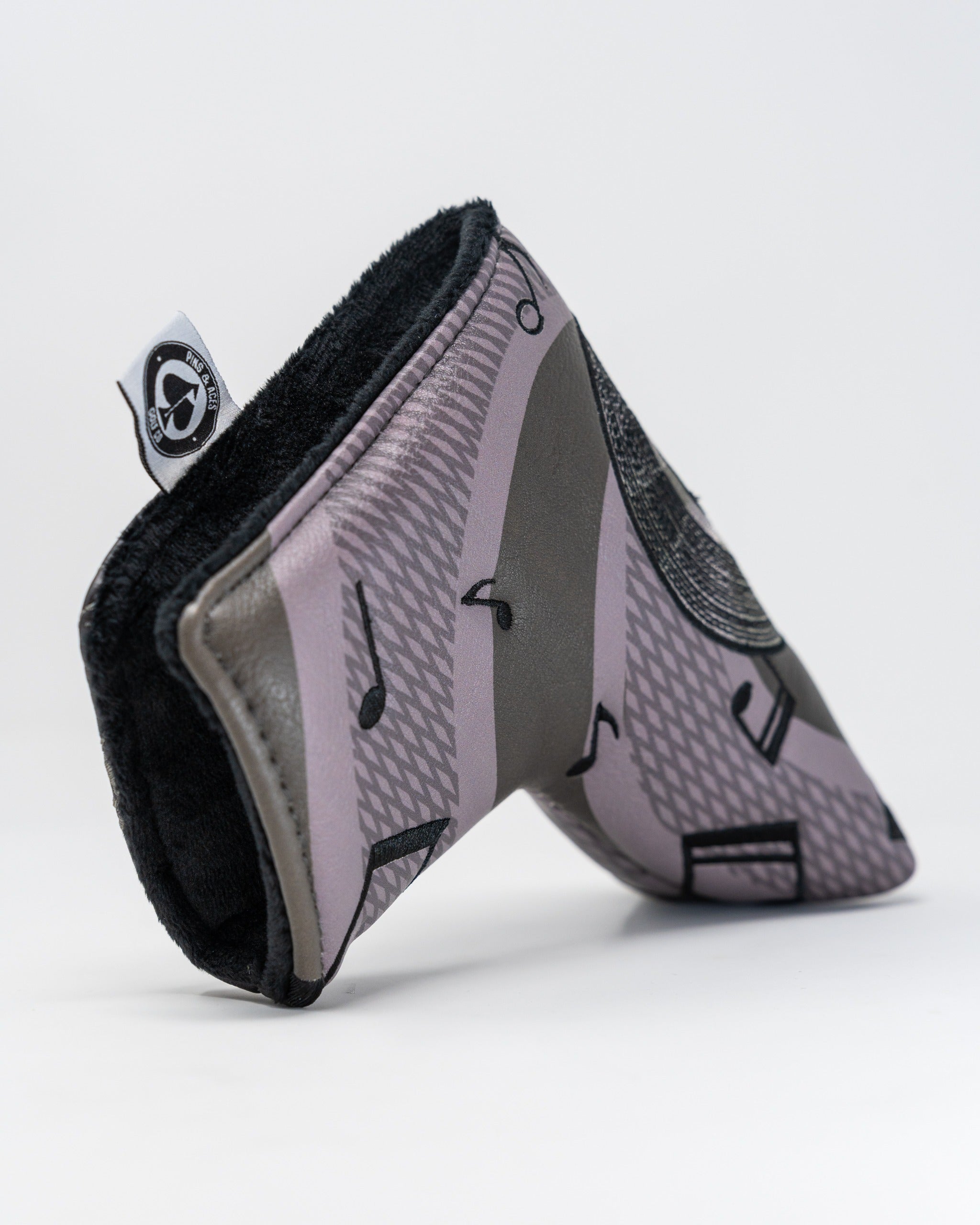 Music City blade putter cover featuring a stylish music note design and soft interior for protection on the golf course.