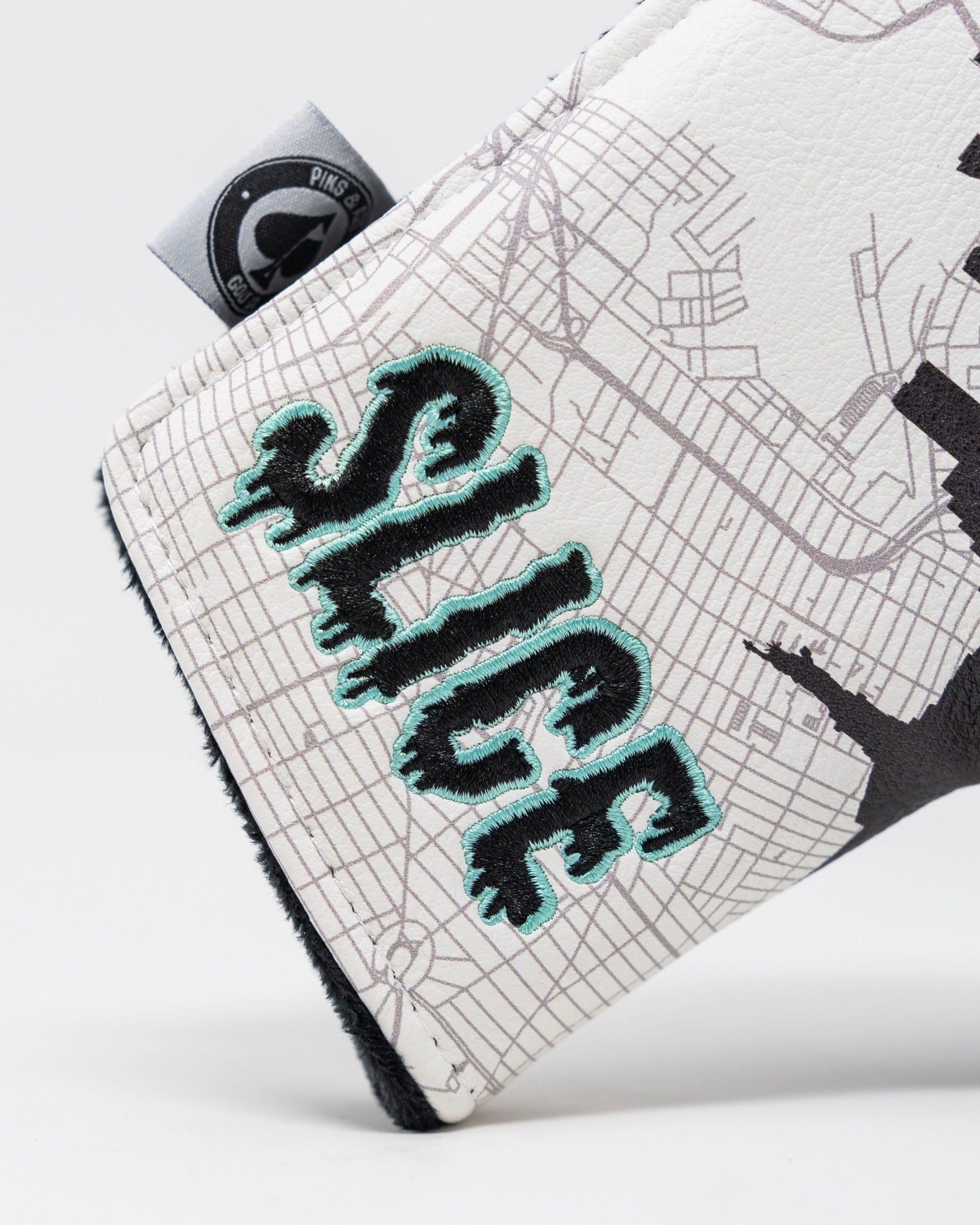 Bold Shady Slice blade putter cover featuring a unique design with vibrant lettering and a sleek finish for standout style.