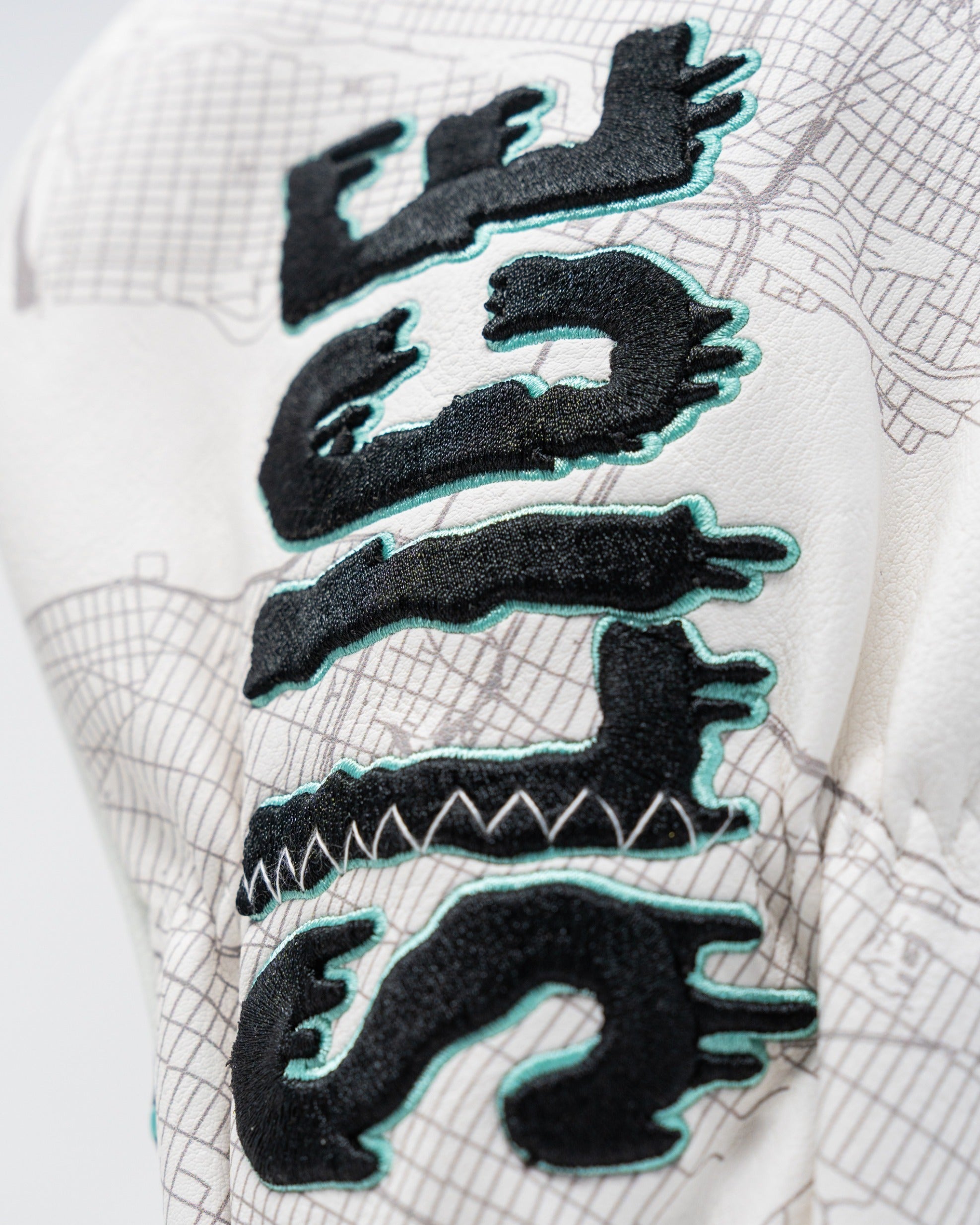 Shady Slice Fairway Cover featuring bold black and teal embroidery on a textured white background.