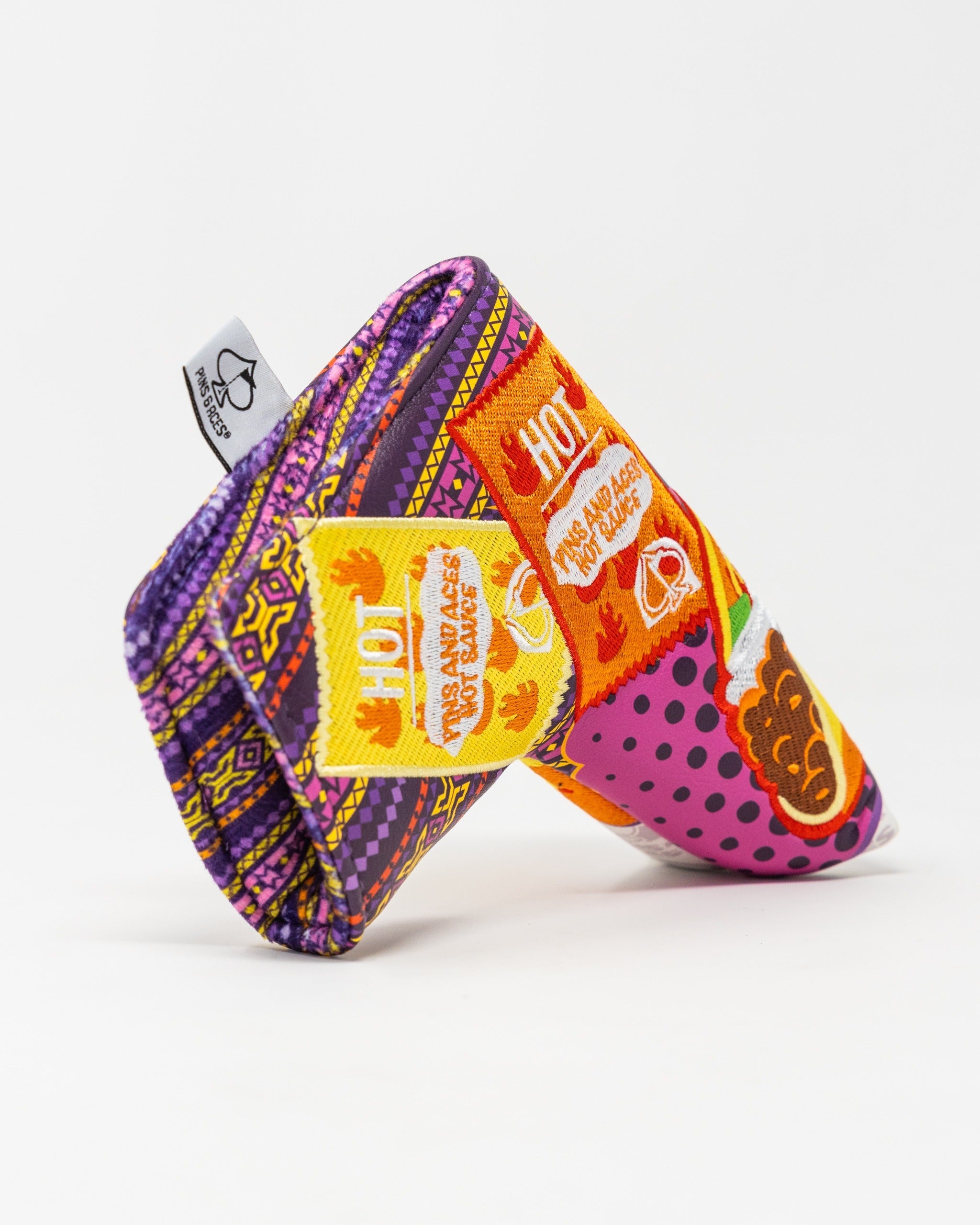 Vibrant blade putter cover featuring bold patterns and colors, designed for golfers seeking unique style on the course.