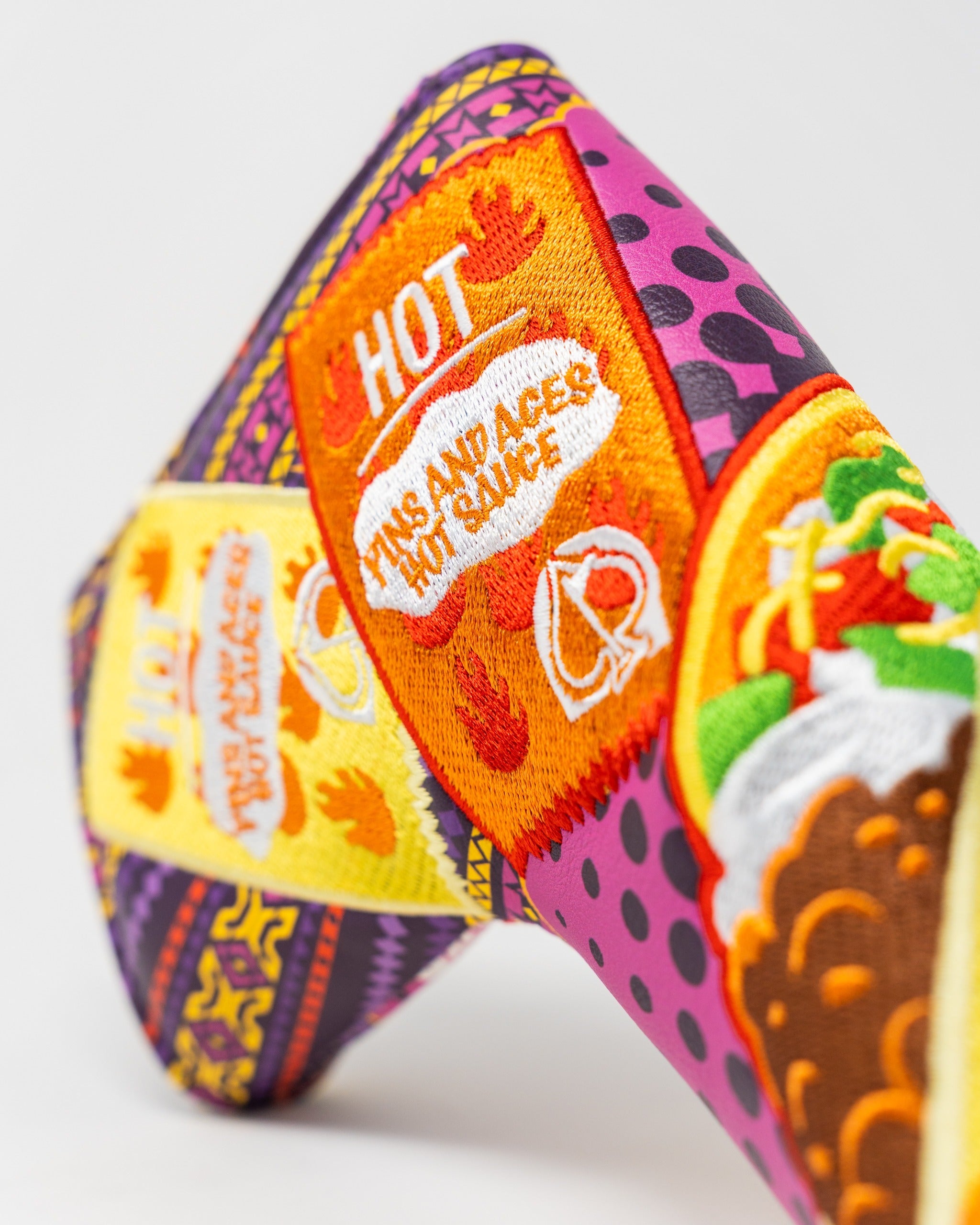 Colorful blade putter cover featuring bold graphics and vibrant designs, perfect for golfers seeking a standout accessory.