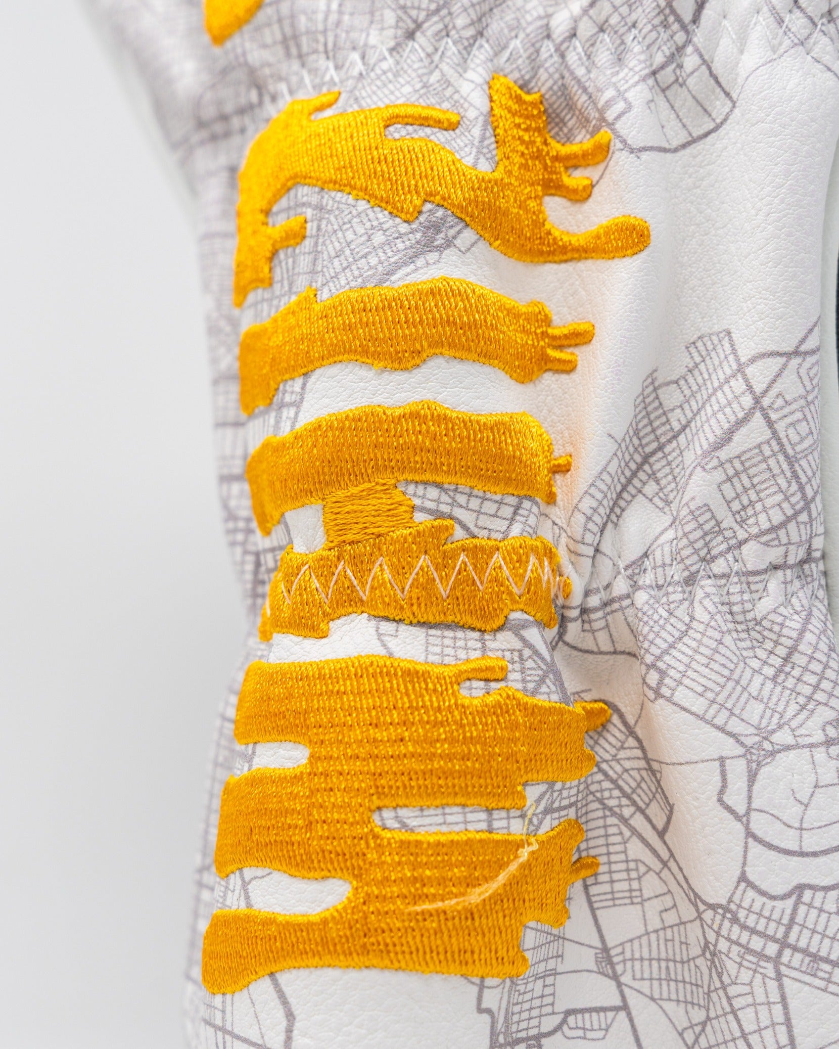 Whiz Wit Fairway Cover featuring bold yellow embroidery on a textured white background with a map design.