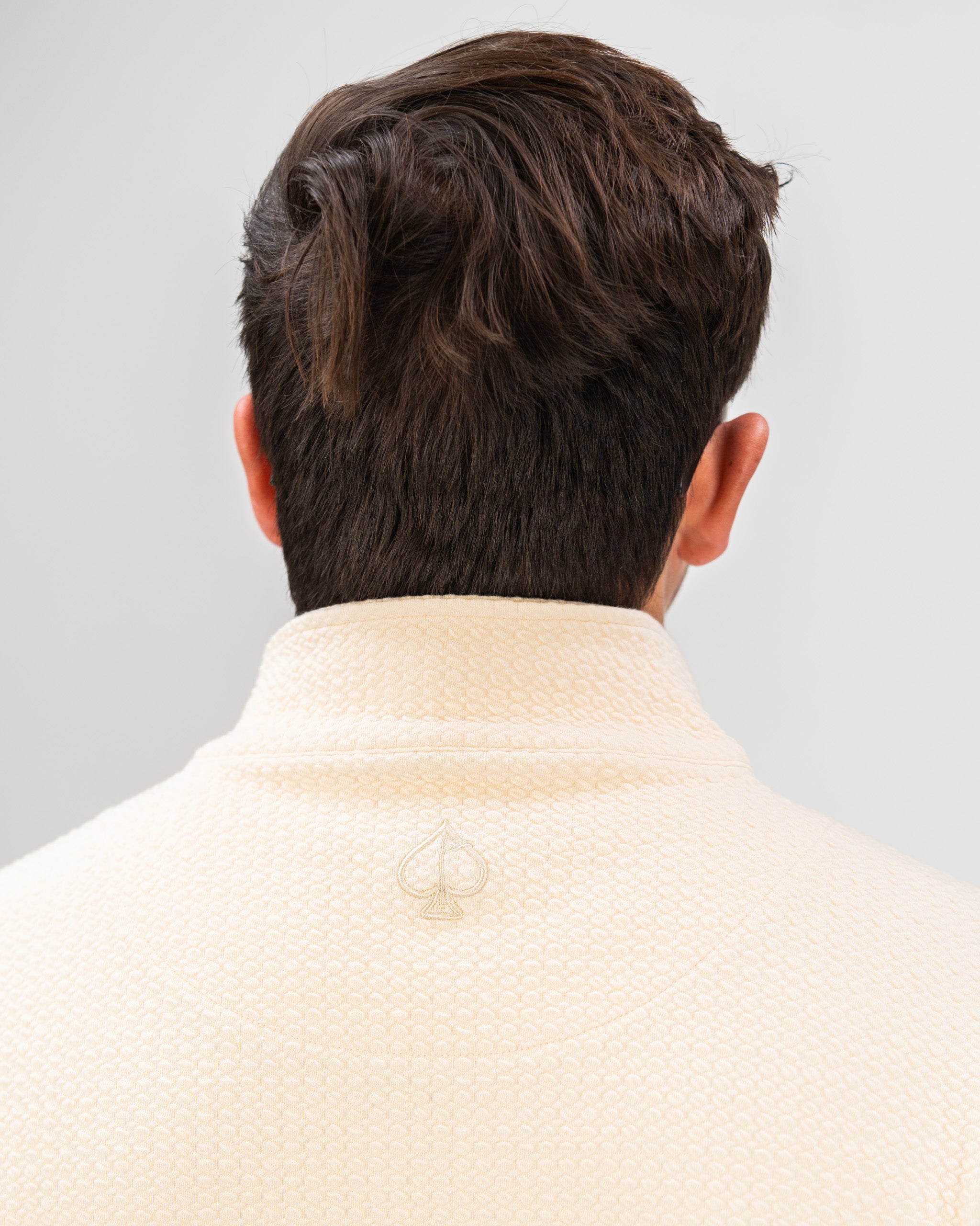 Cream Player Preferred Waffle Knit Pullover showcasing a textured design and logo detail on the back collar.