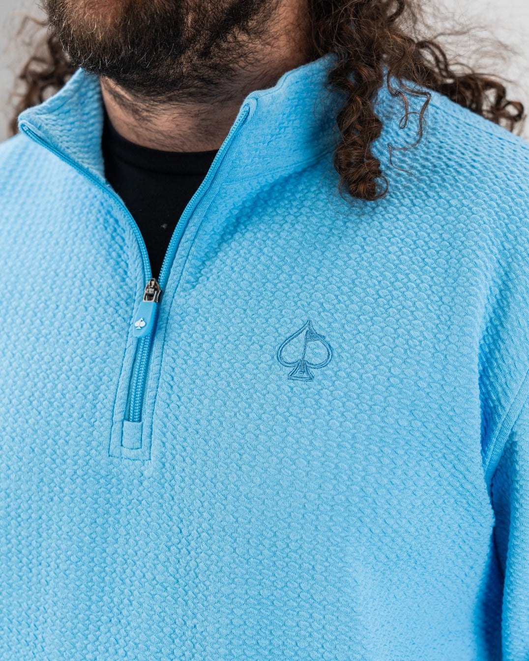 Blue Steel Player Preferred Waffle Knit Pullover featuring a quarter-zip and embroidered logo, ideal for stylish golf outings.