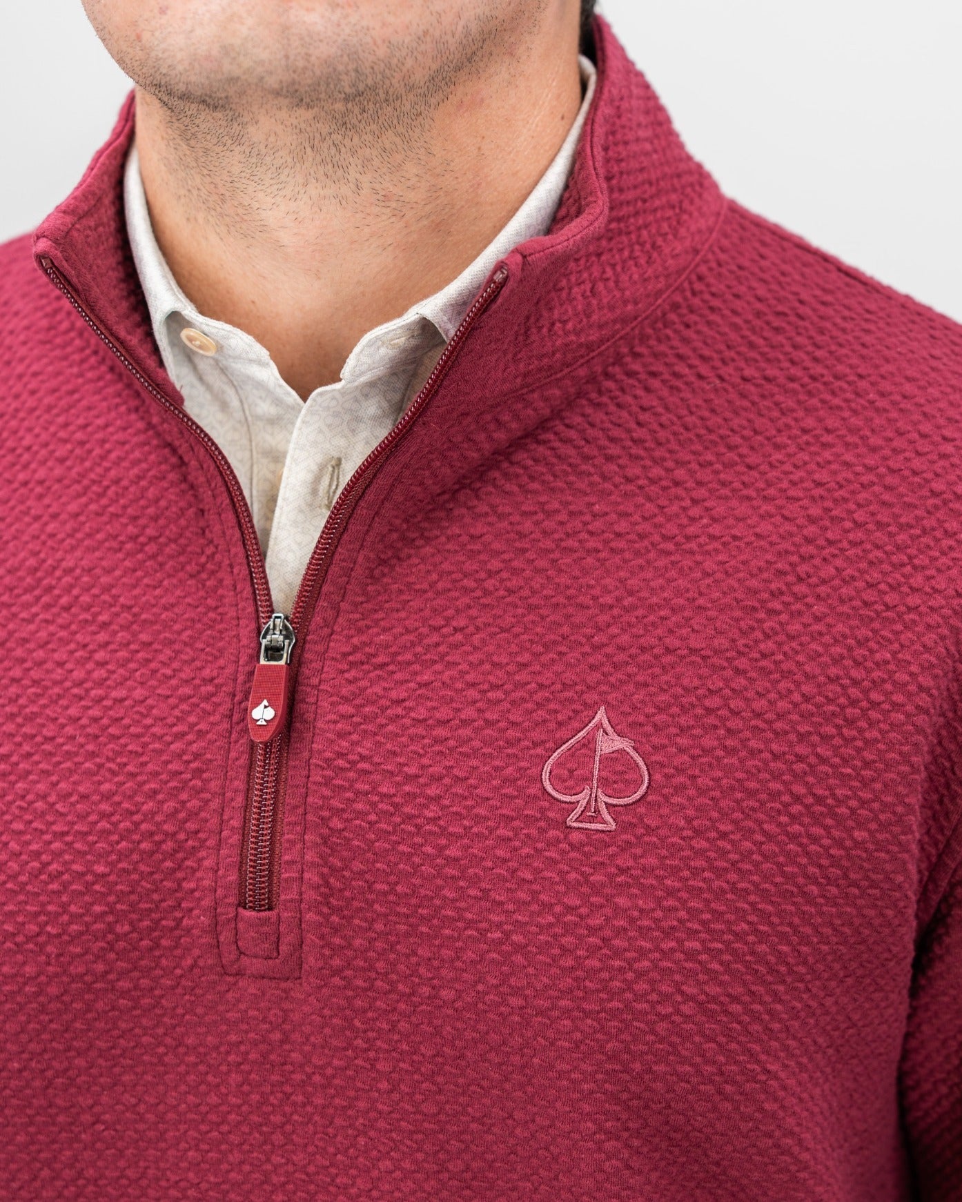 Men's Player Preferred Waffle Knit Pullover in Merlot features a quarter-zip design and a subtle logo on the chest.