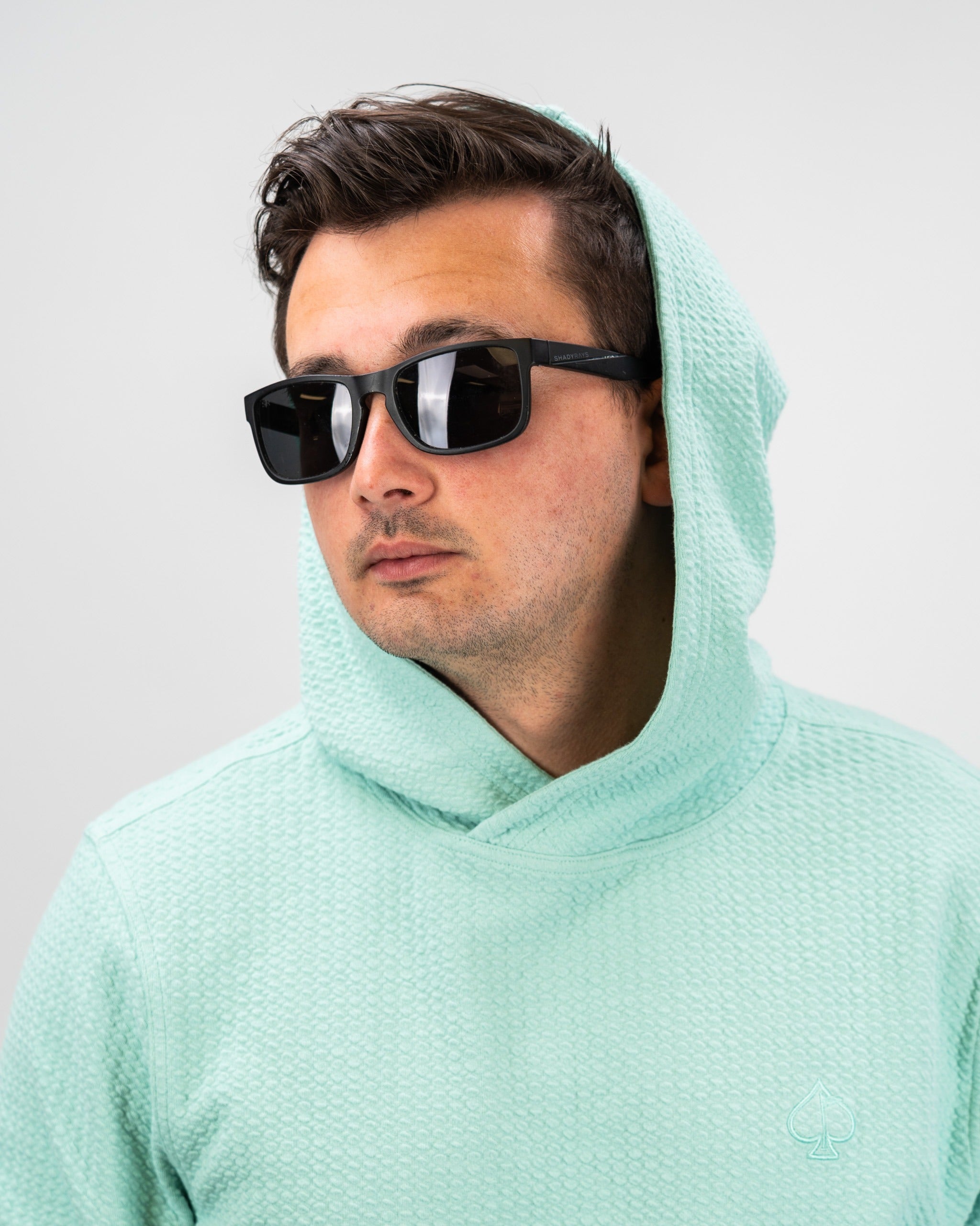 Bright mint waffle knit hoodie with a relaxed fit, featuring a hood and a subtle logo, perfect for stylish golfers.