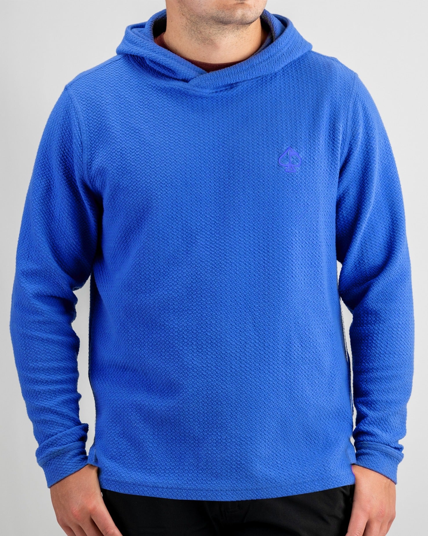 Cobalt blue waffle knit hoodie featuring a relaxed fit and logo, perfect for stylish comfort on and off the golf course.