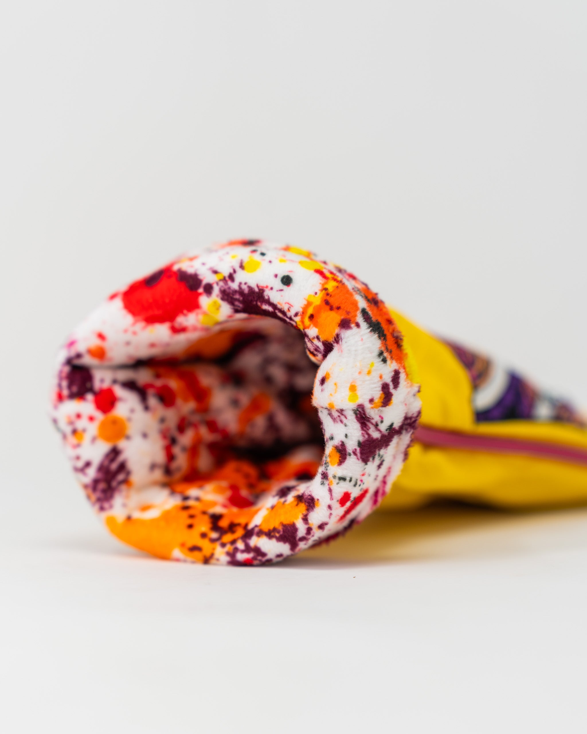 Brightly colored pink lemonade hybrid golf headcover featuring a unique splash design, perfect for stylish golfers.