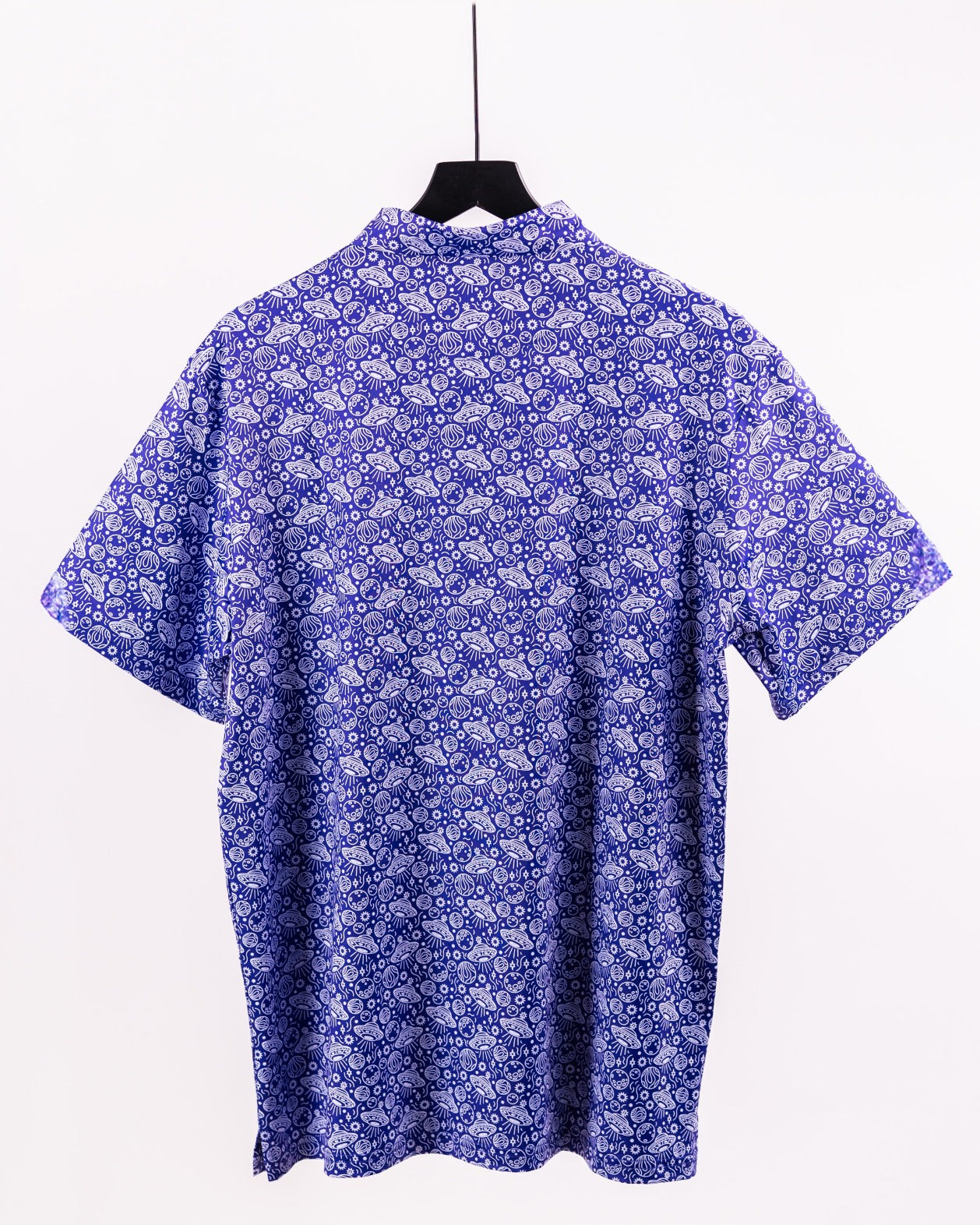 Back view of the HEYDUDE Indigolactic shirt featuring a vibrant blue pattern, perfect for stylish golf outings.