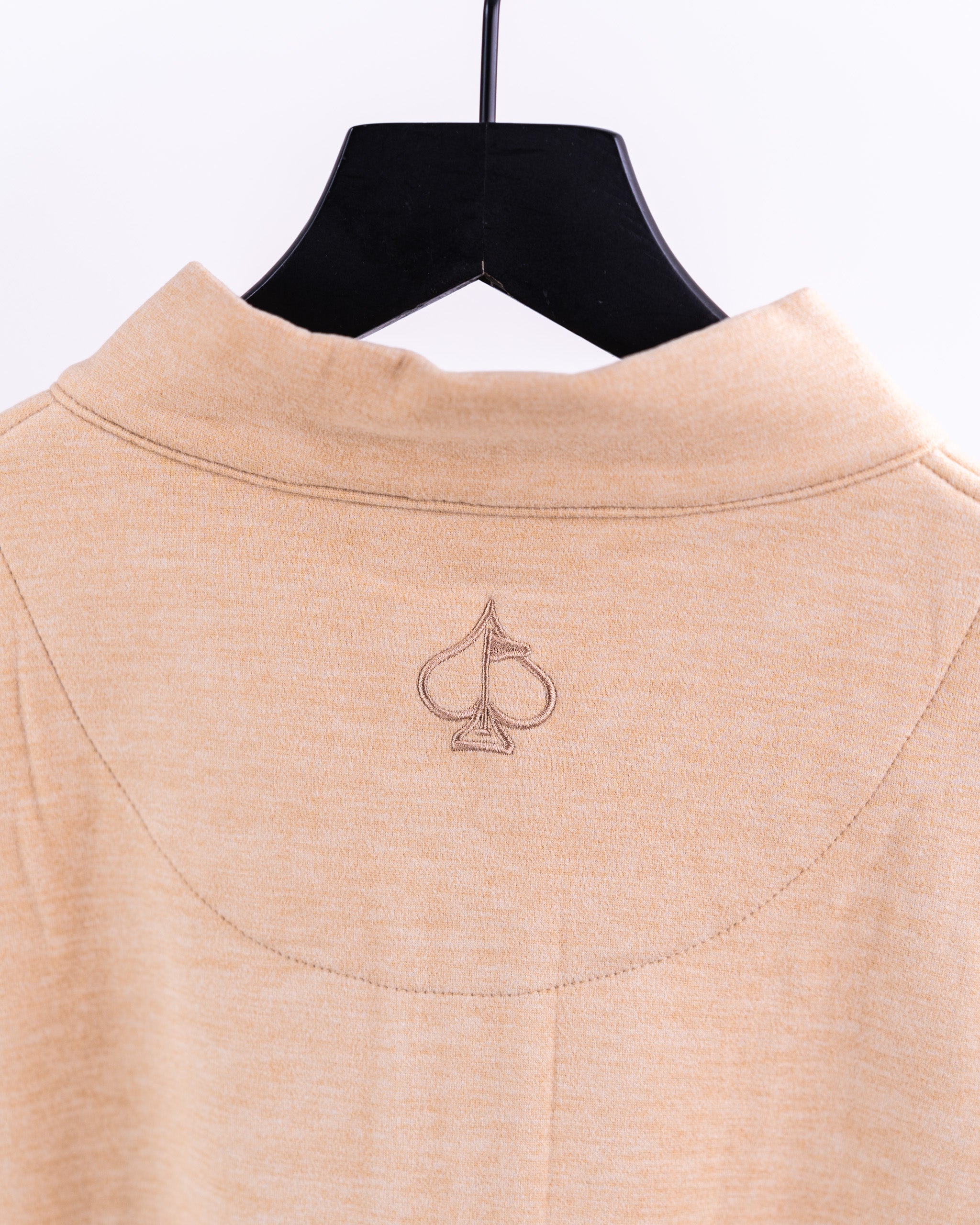 Sand-colored Player Preferred pullover featuring a subtle embroidered logo on the back collar, perfect for golfers.