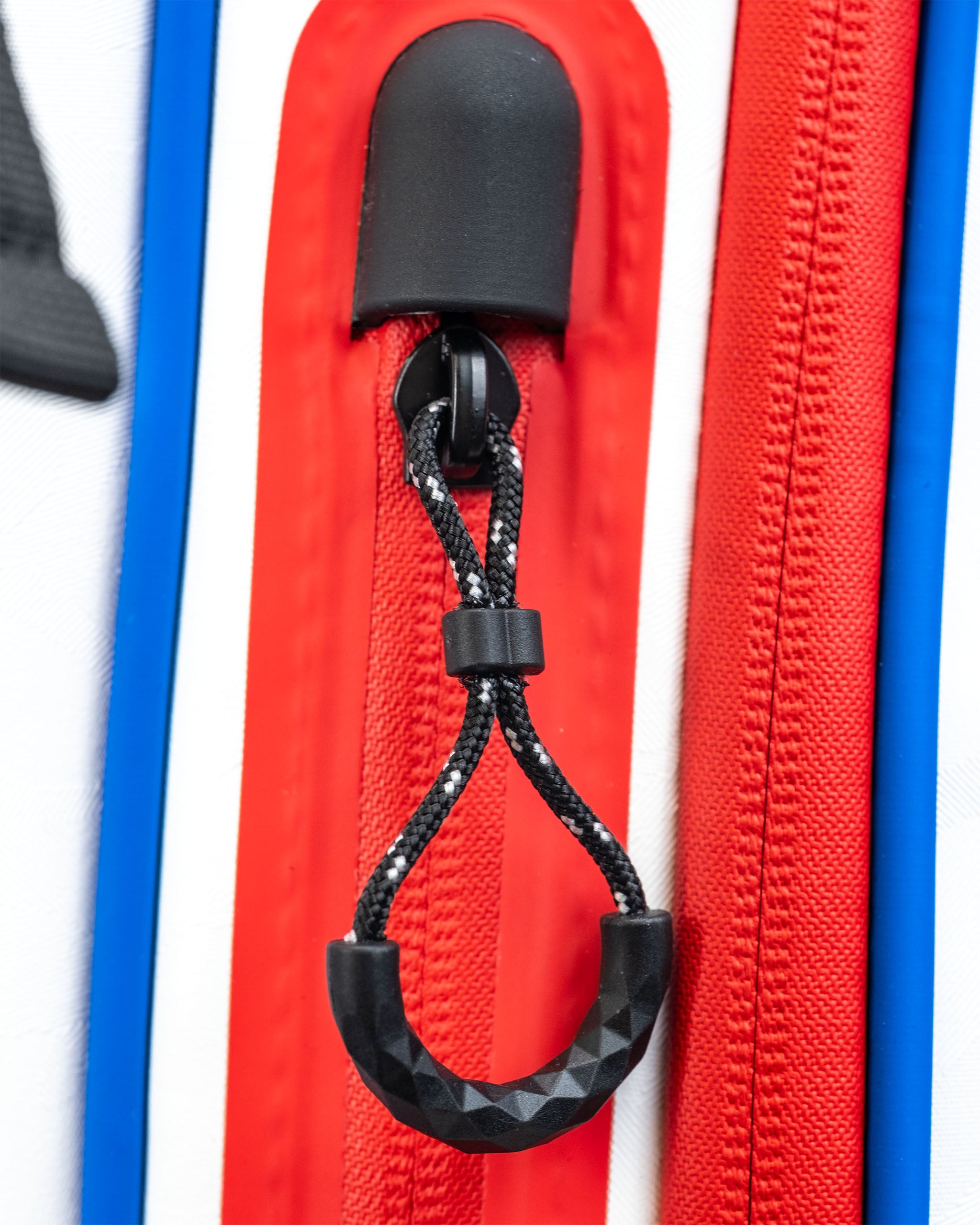 Close-up of the Player Preferred™ Golf Bag zipper pull, featuring a durable black cord and a textured grip for easy handling.