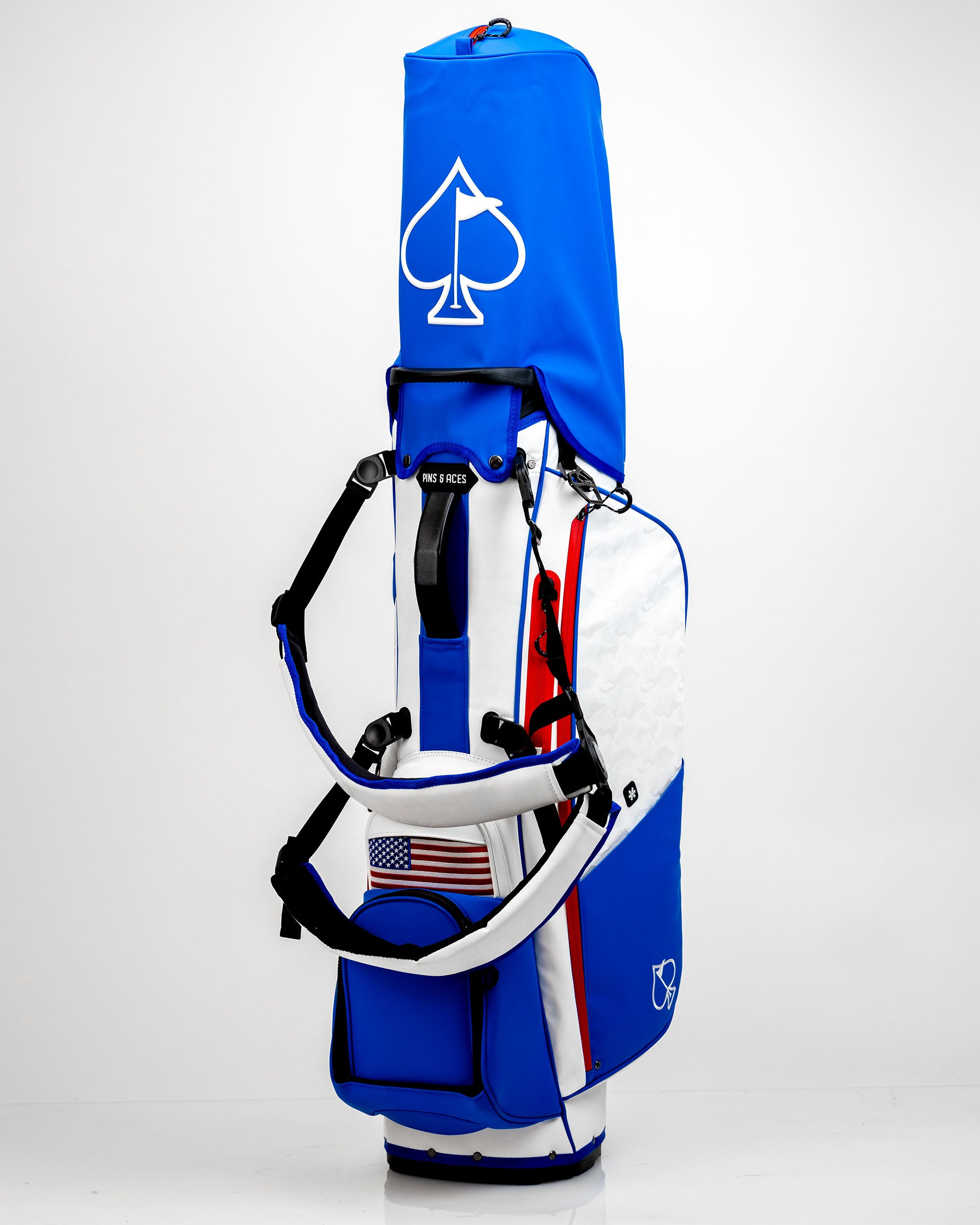 Bold blue Player Preferred™ Golf Bag featuring a white spade logo, padded straps, and an American flag patch. Ideal for stylish golfers.