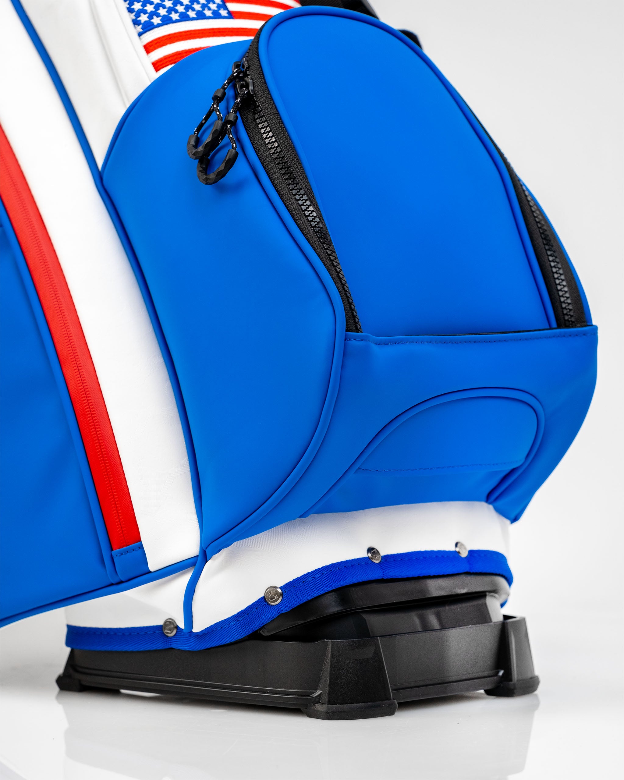 Close-up of the Player Preferred Golf Bag featuring a vibrant blue design with red and white accents and a sturdy base.