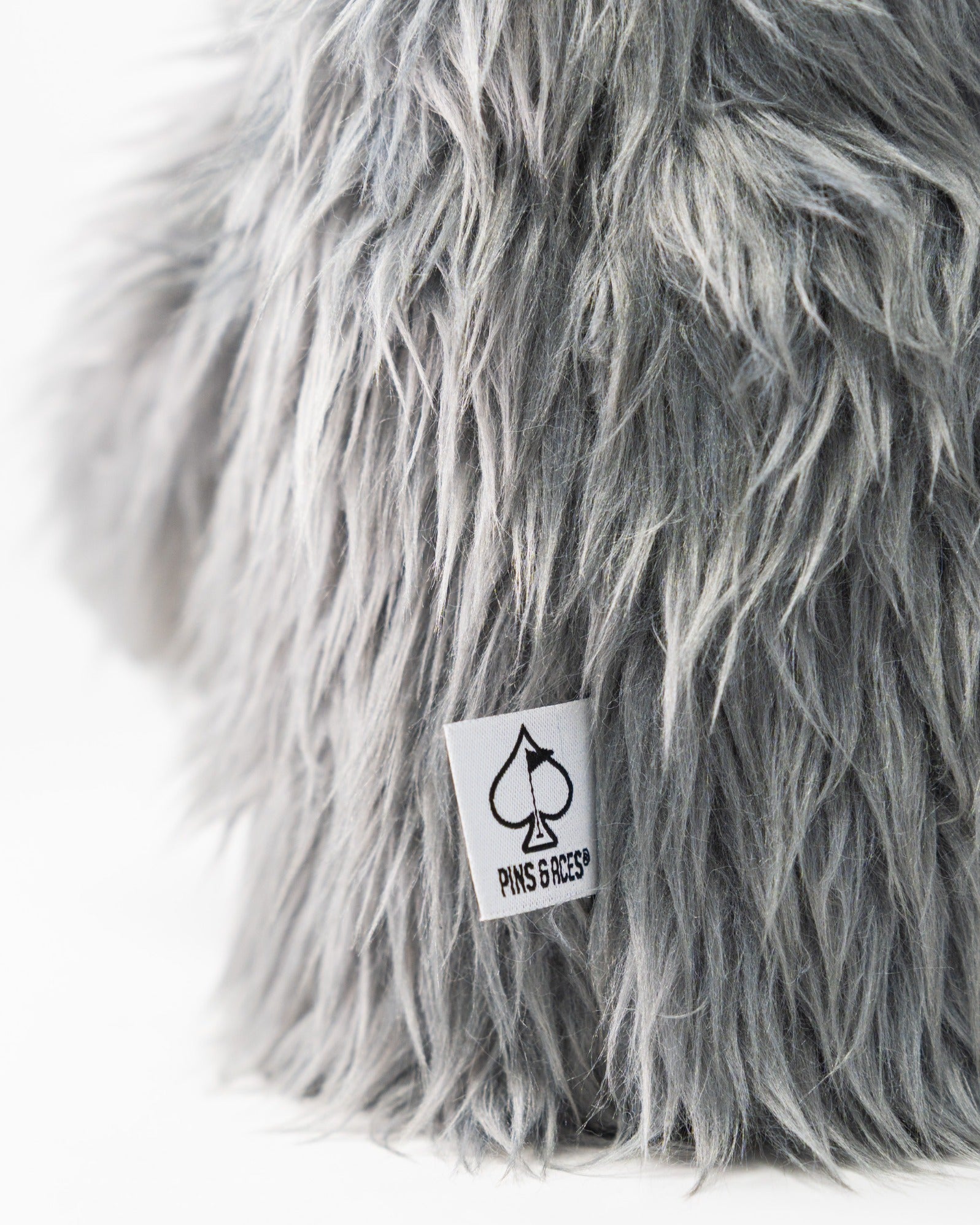 Soft, gray koala driver cover with a fluffy texture and a Pins and Aces logo tag, perfect for adding style on the golf course.