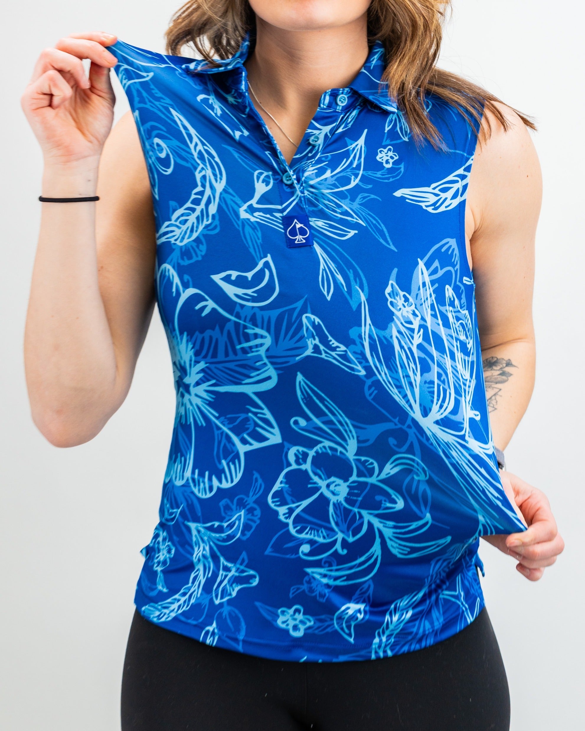 Women's Cabo Ocean sleeveless golf polo in vibrant blue with floral patterns, perfect for stylish performance on the course.