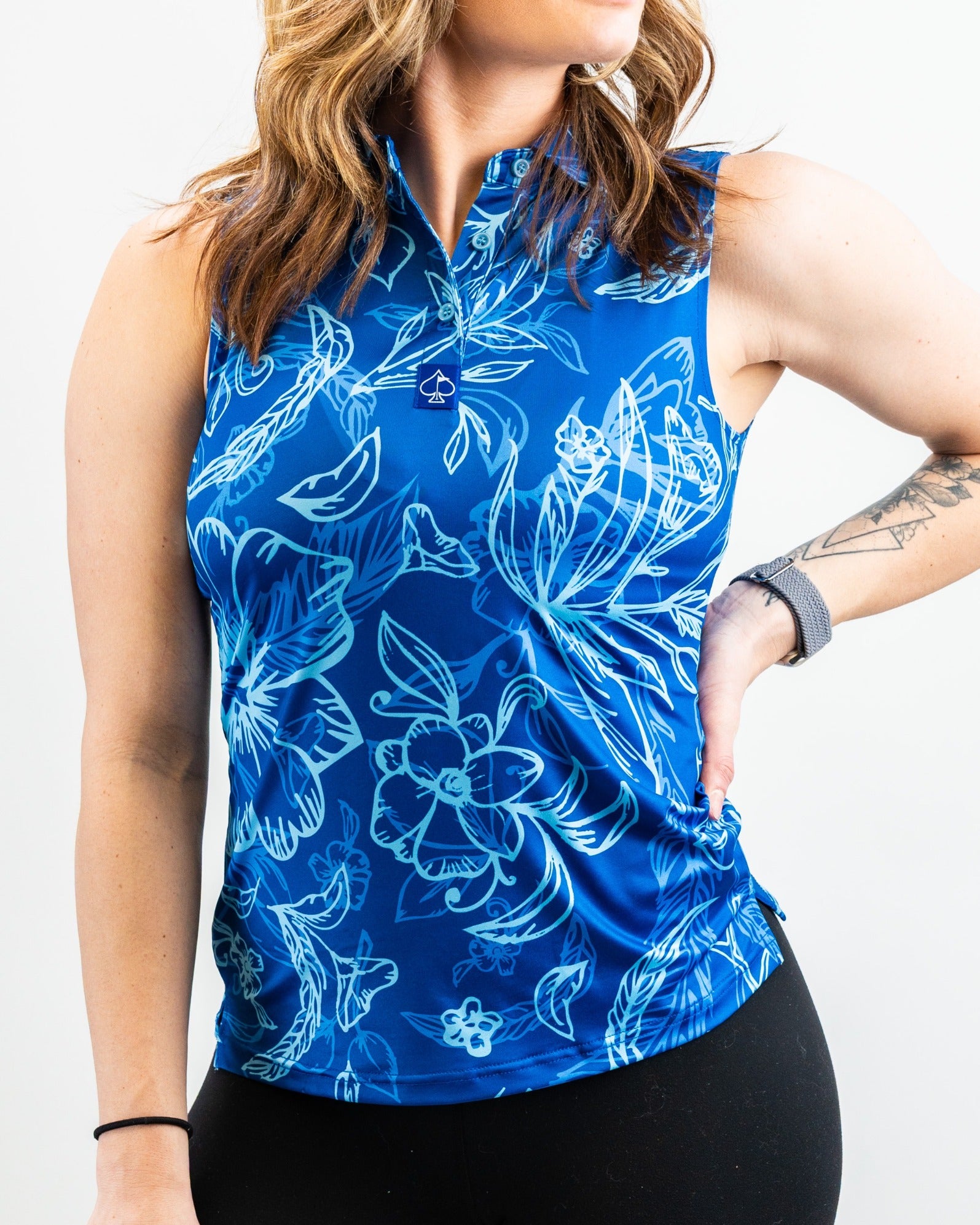 Women's Cabo Ocean sleeveless golf top featuring a vibrant blue floral design, perfect for stylish performance on the course.