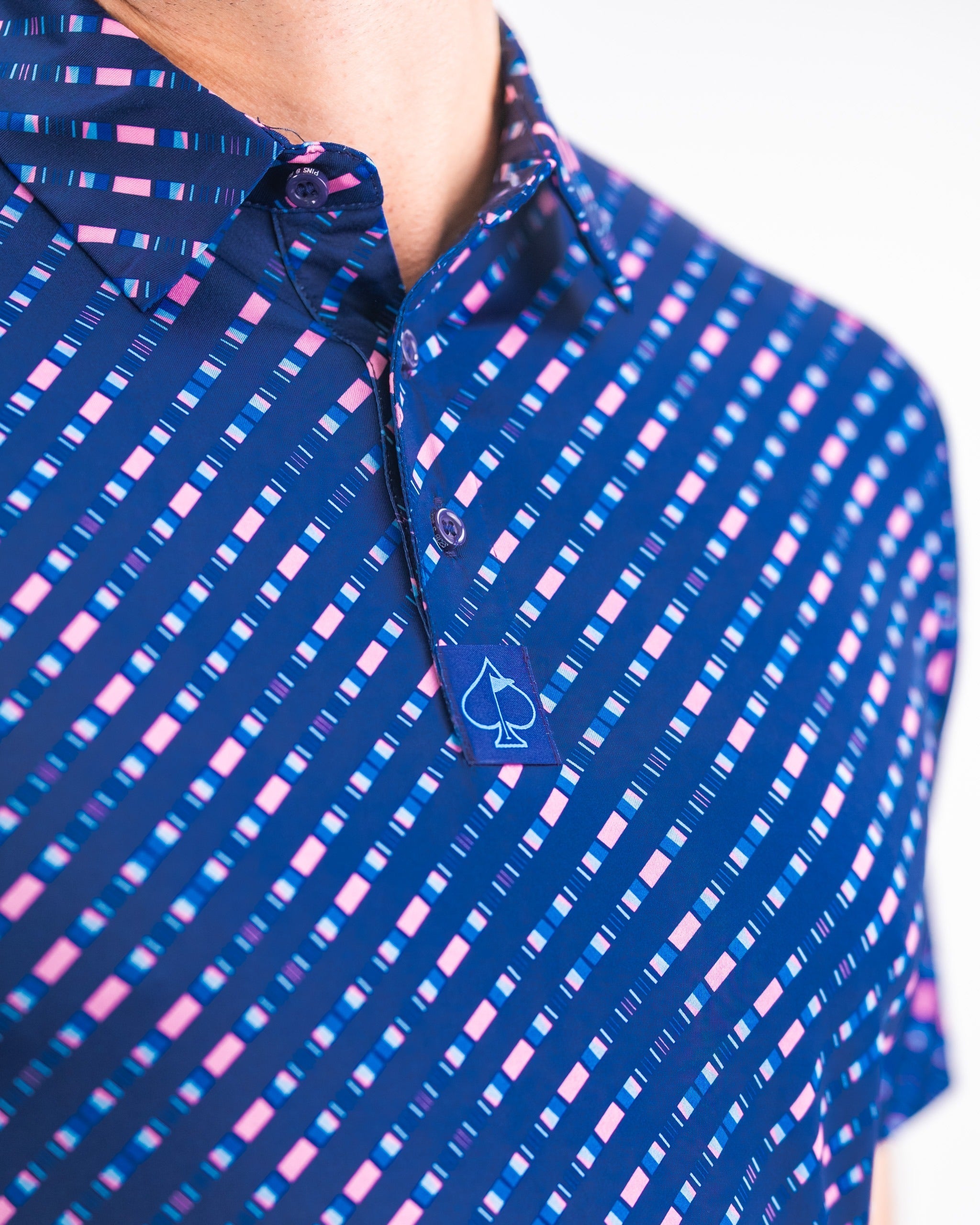 Bold blue golf polo featuring a unique striped pattern in pink and light blue, designed for a standout look on the course.