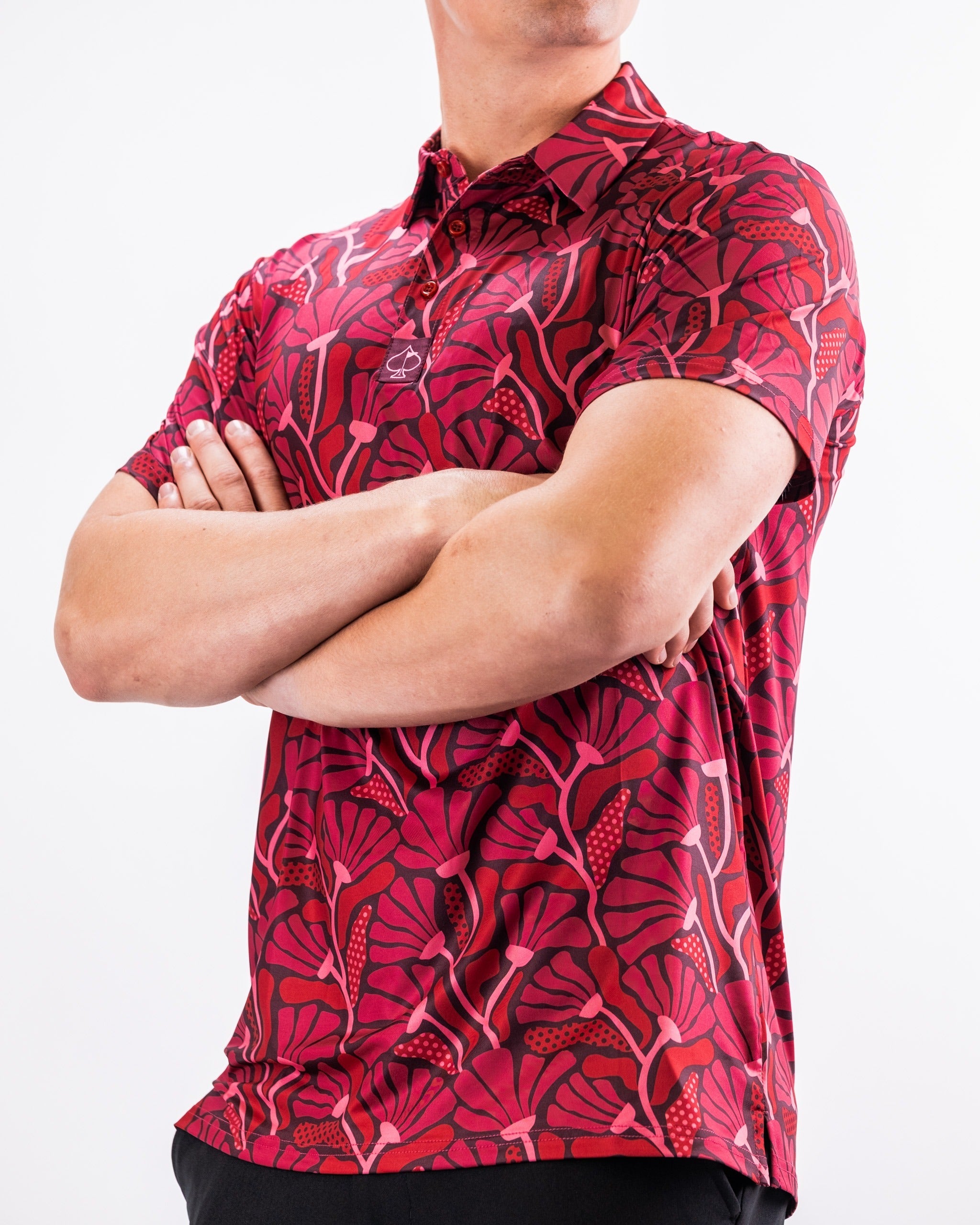 Men's crimson golf polo featuring a vibrant floral pattern, perfect for stylish performance on the course.