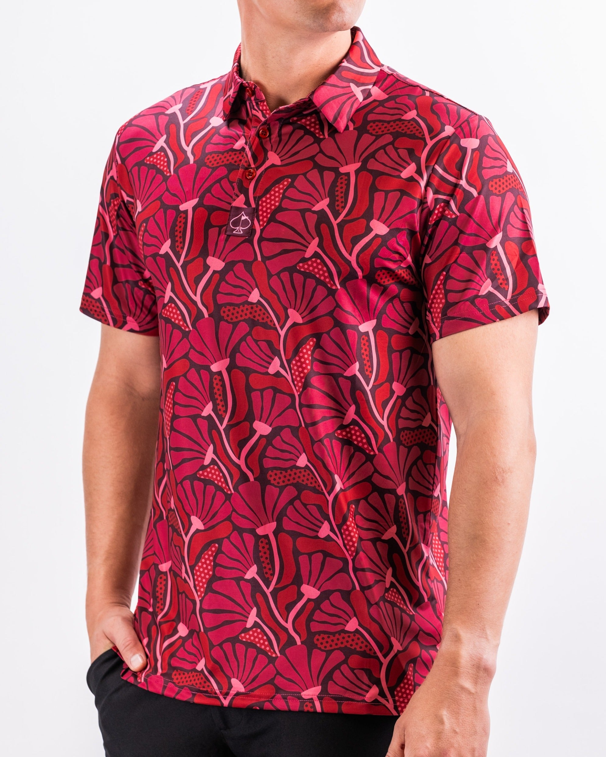 Bold crimson golf polo featuring a vibrant floral pattern, perfect for golfers looking to make a statement on the course.