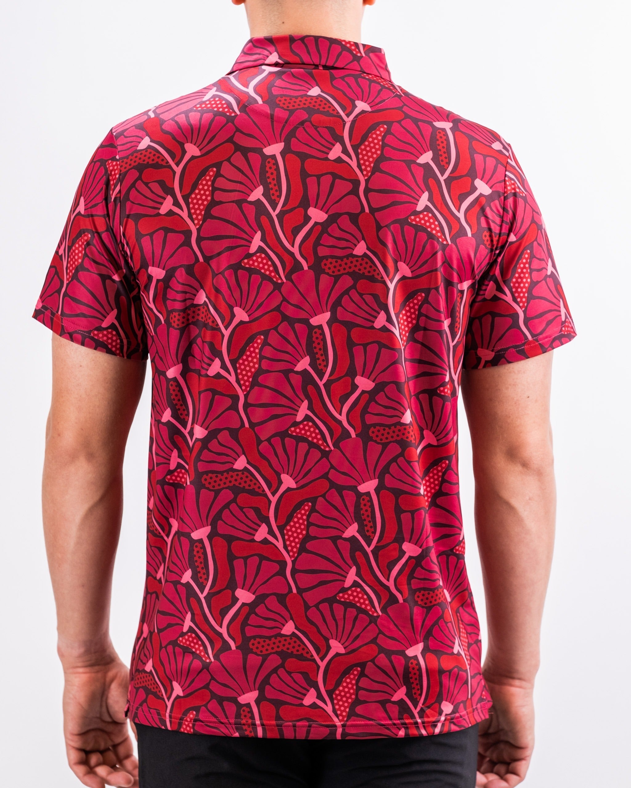 Men's short-sleeve shirt featuring a vibrant crimson floral pattern, ideal for stylish golf outings or casual wear.