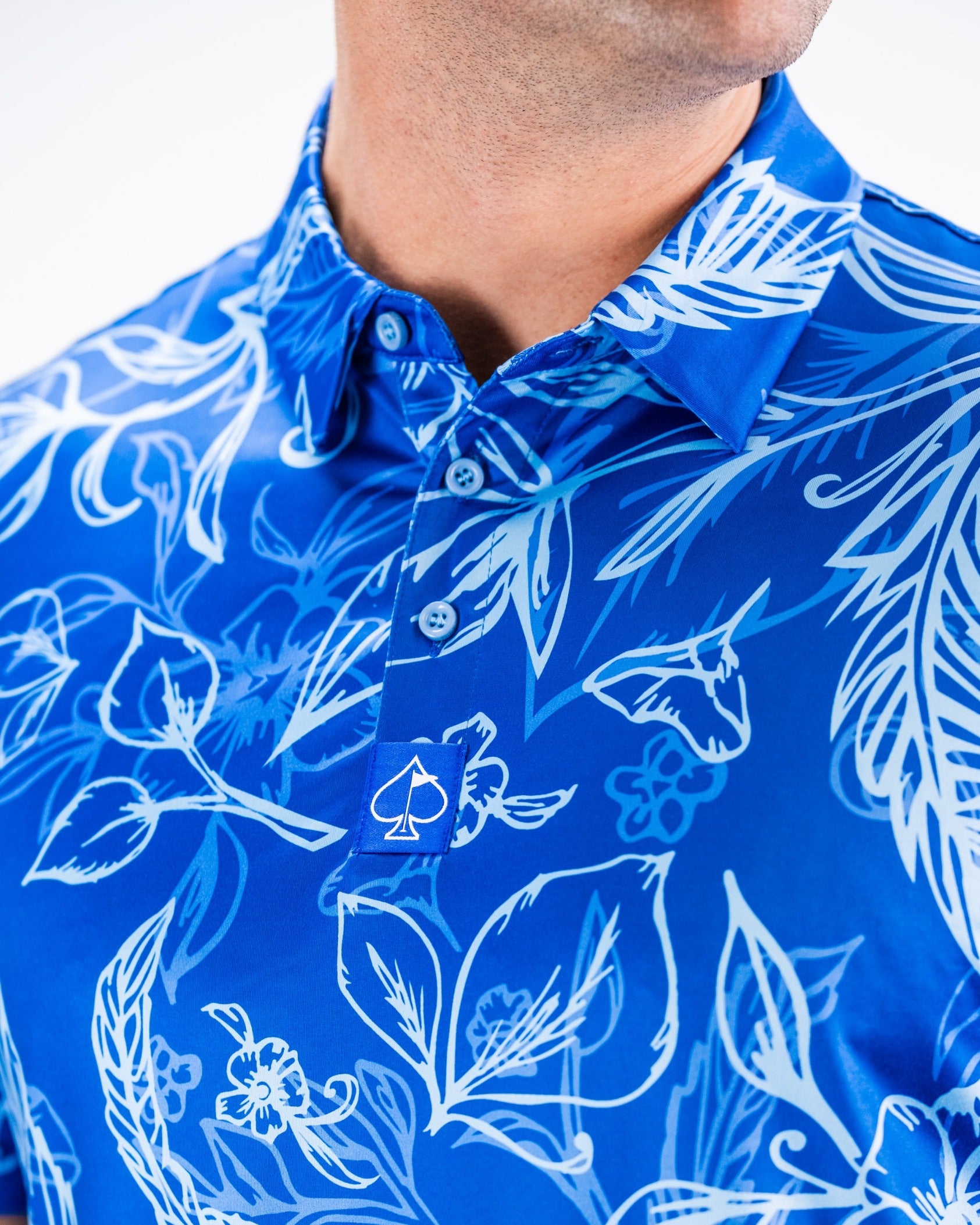 Bold blue golf polo shirt featuring a vibrant floral pattern, designed for golfers who want to stand out on the course.