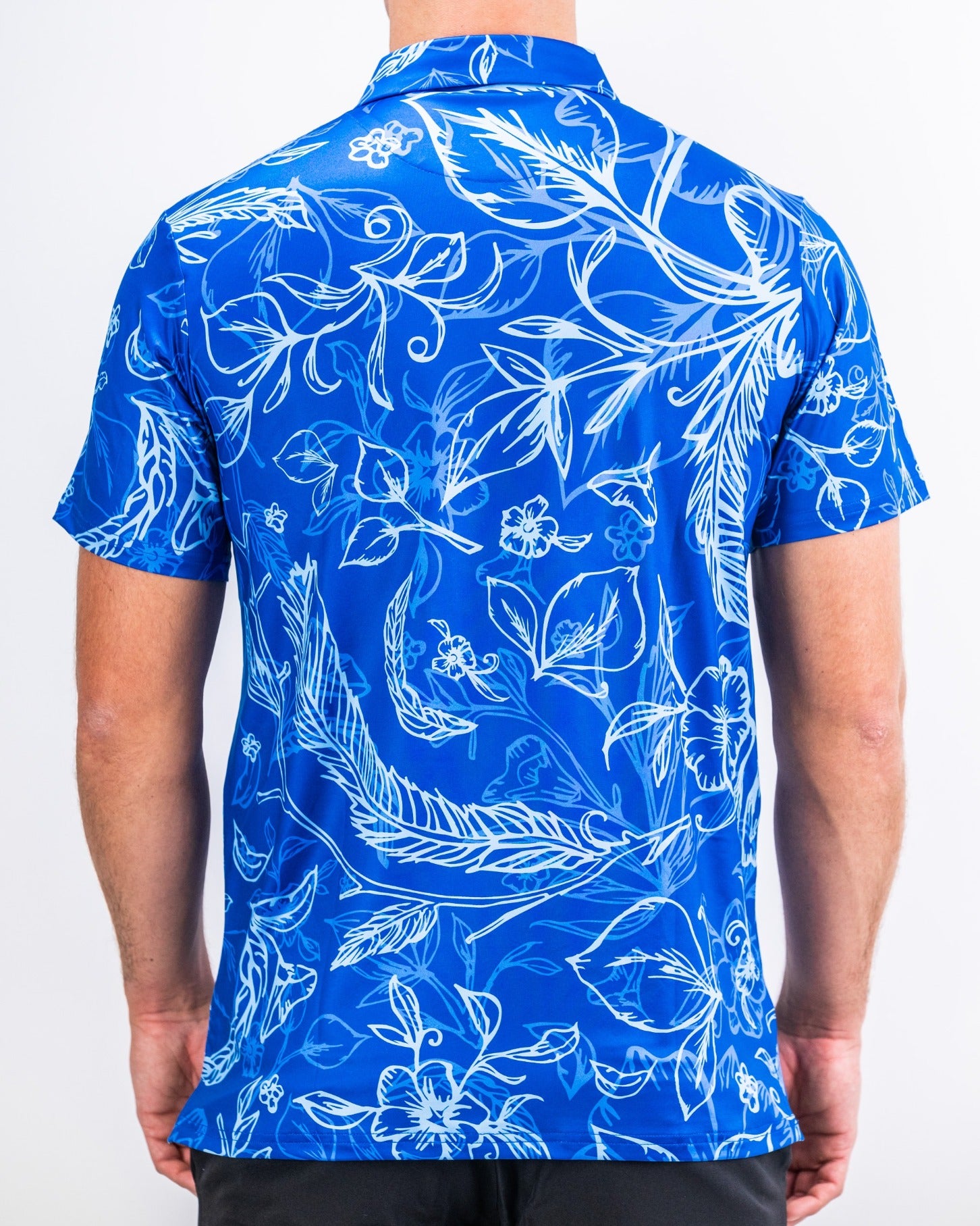 Bold blue golf shirt featuring a vibrant floral and leaf pattern, designed for golfers who want to make a statement on the course.