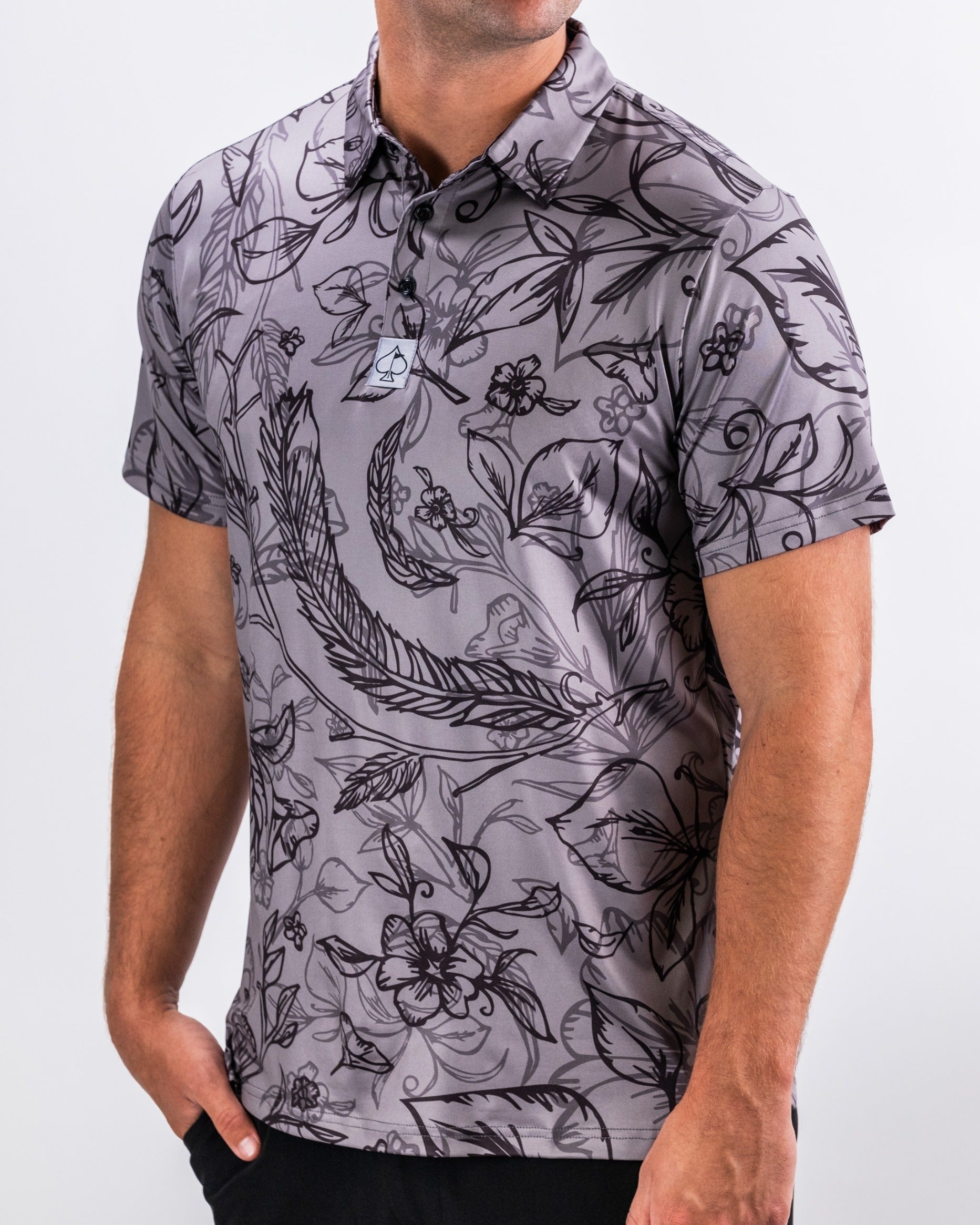 Men's Cabo Midnight golf polo featuring a bold floral pattern in shades of gray and black, perfect for stylish play on the course.