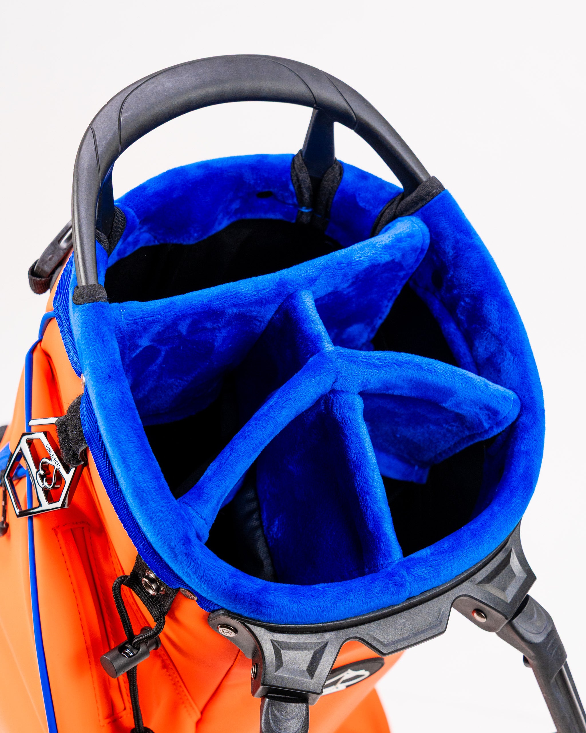 Interior view of the Player Preferred Golf Bag in Orange Crush, featuring a blue padded top with four club dividers.