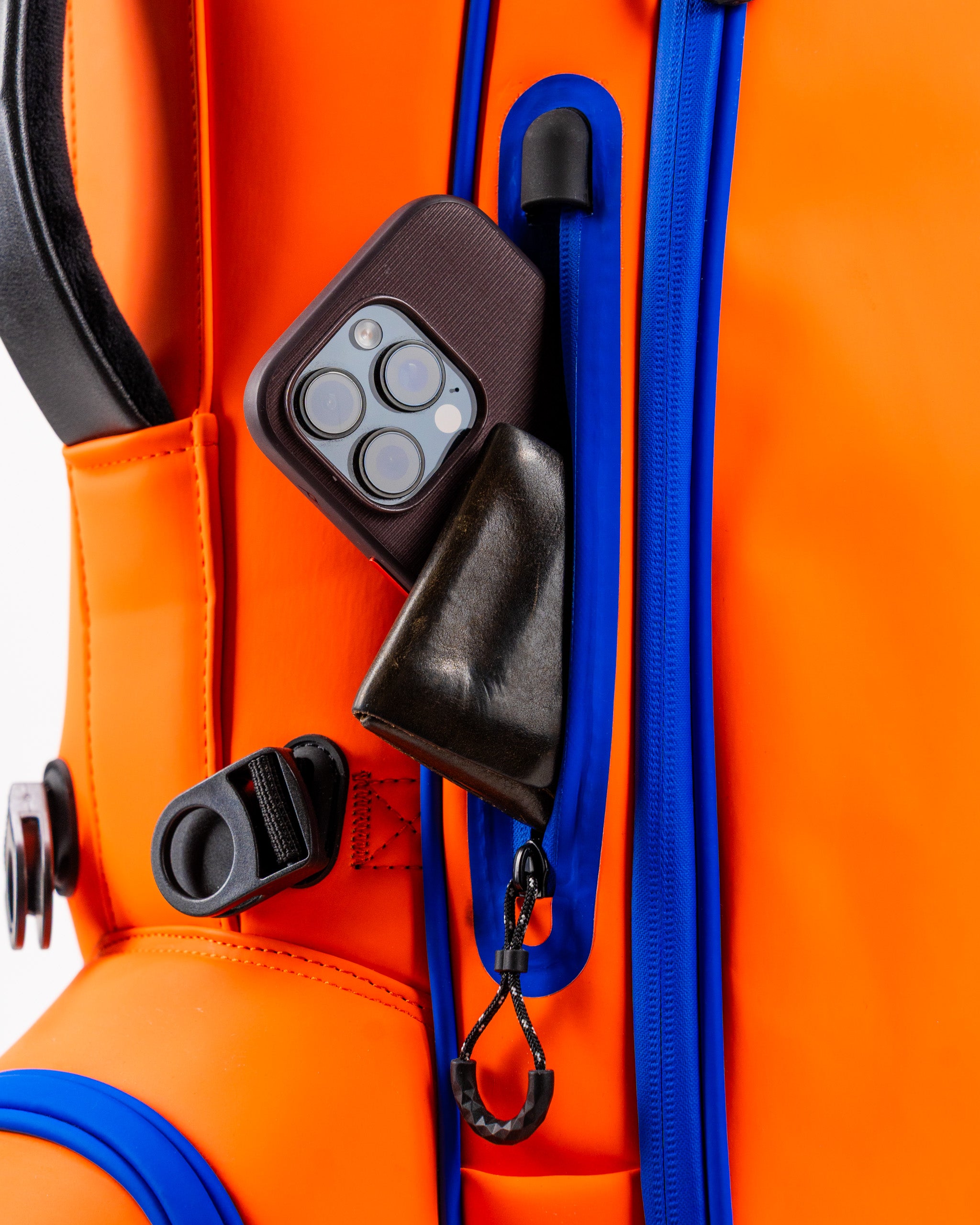 Close-up of the Player Preferred Golf Bag in Orange Crush, featuring a phone pocket and sleek design elements.