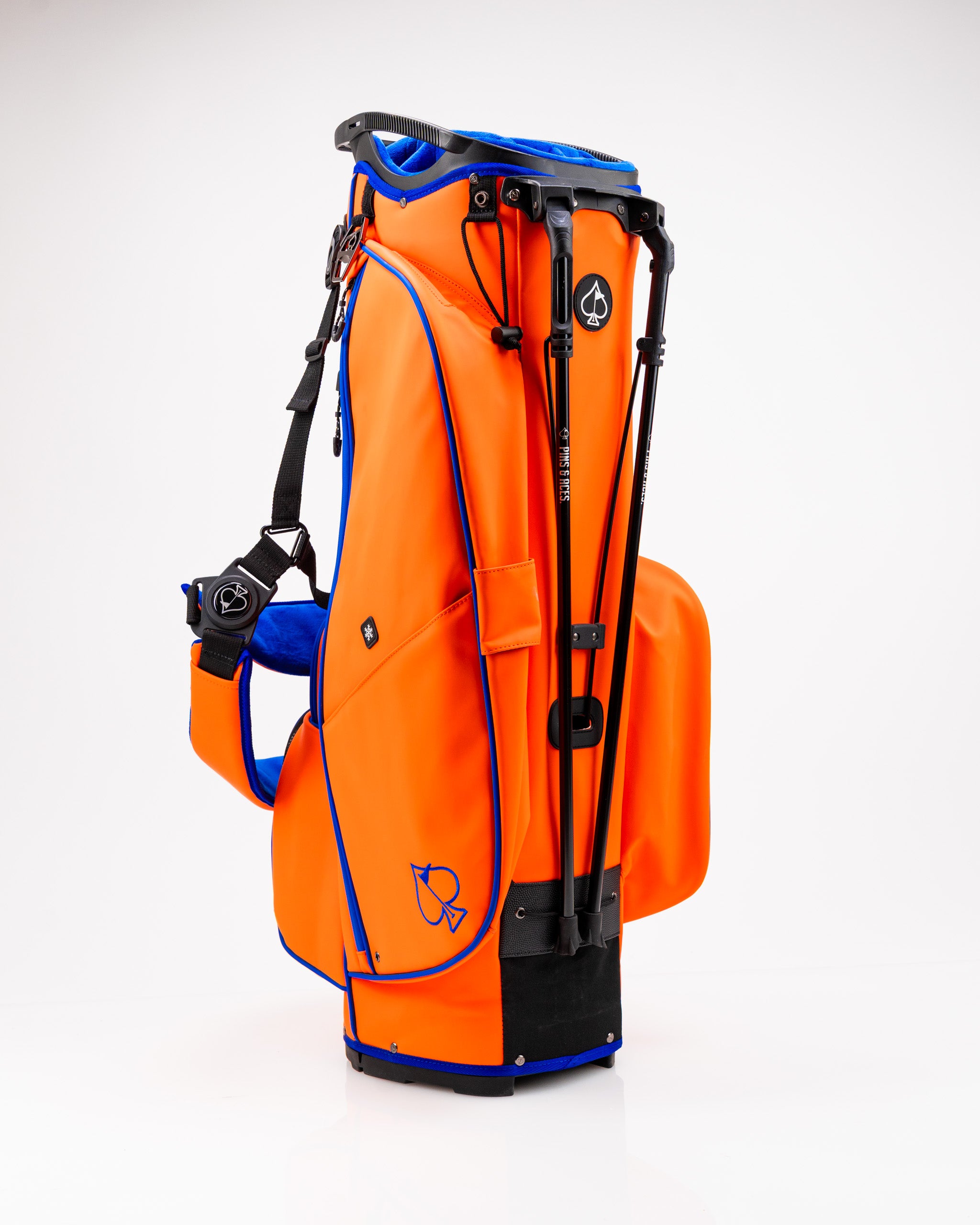 Bright orange golf bag with blue accents, featuring a sleek design and multiple pockets for golfers seeking style and functionality.