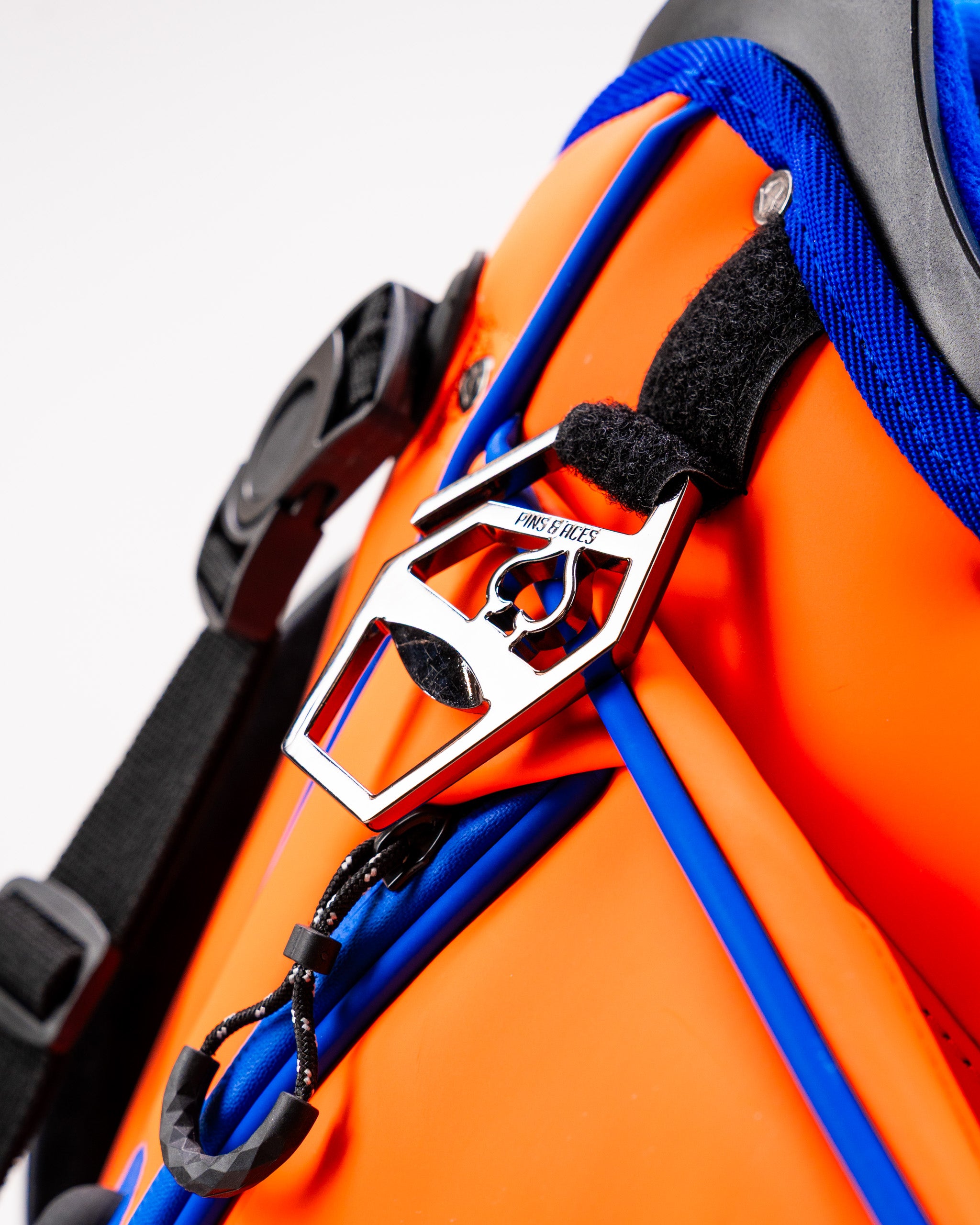 Close-up of the Player Preferred Golf Bag in Orange Crush, showcasing a vibrant orange exterior and a stylish metal buckle.